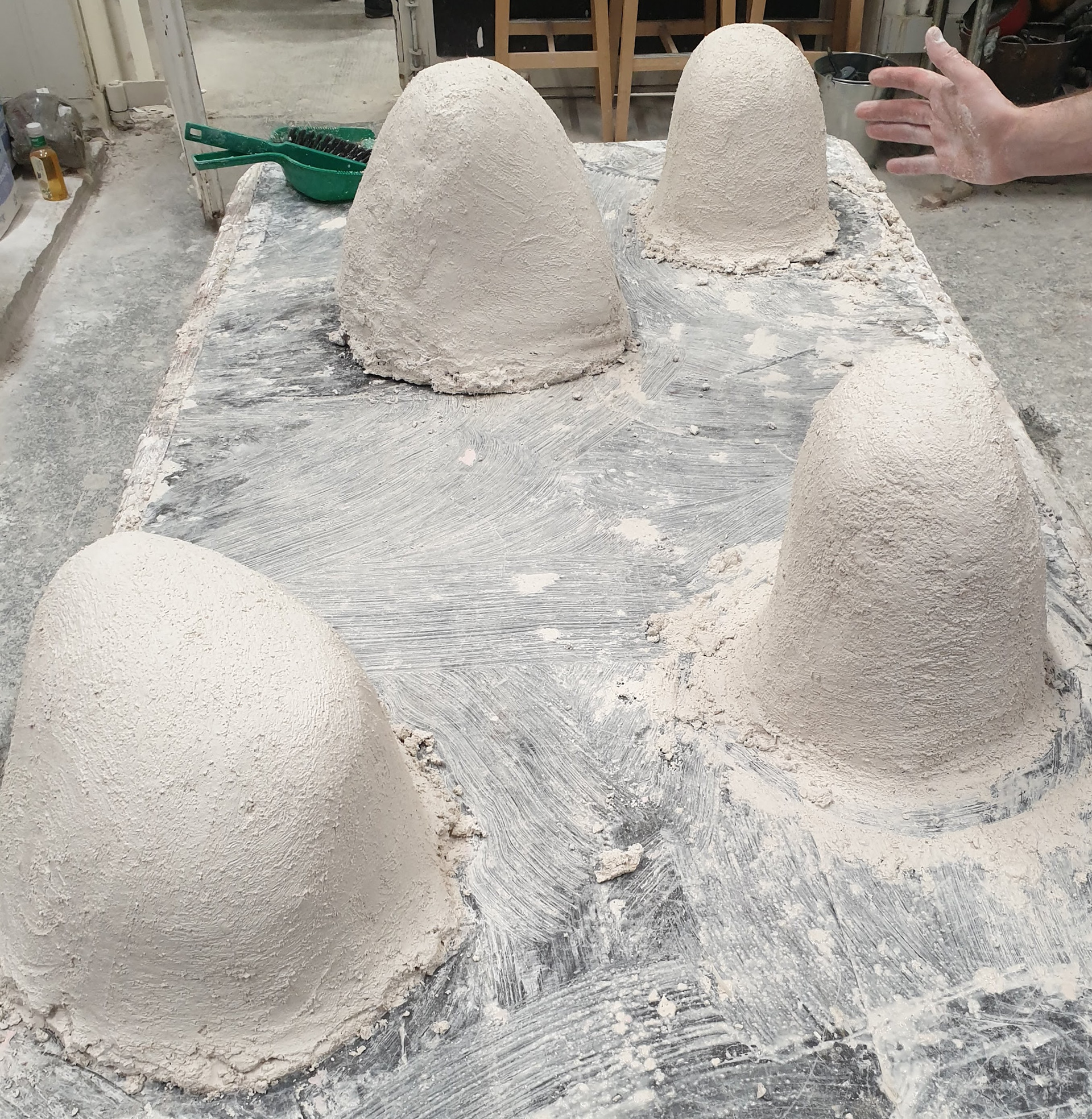 Assembling the plaster mold, building in layers with increased material coarseness and a final layer of chicken wire for structure.