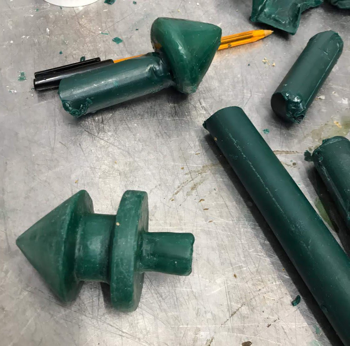 Assembling the wax tree for casting, including runners, risers and the sprue.