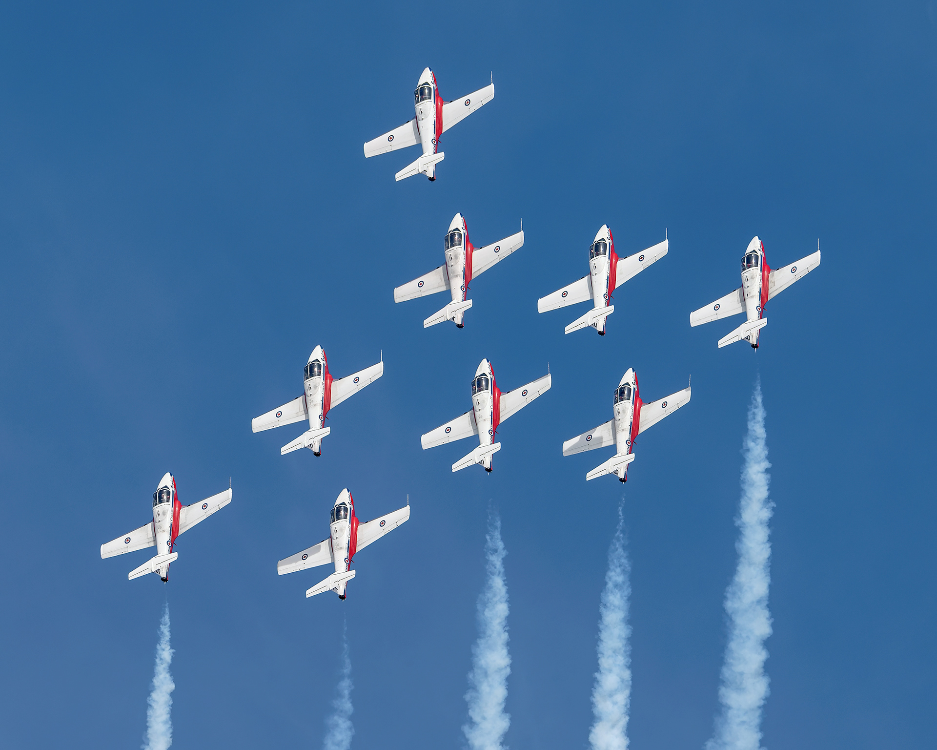 The Canadian Forces Snowbirds (431 Air Demonstration Squadron) perform a precision formation flight, leaving signature white smoke trails against a clear sky during their 2026 spring training demonstration over Vancouver Island. Fine art aviation photography by Kevin Prentice.