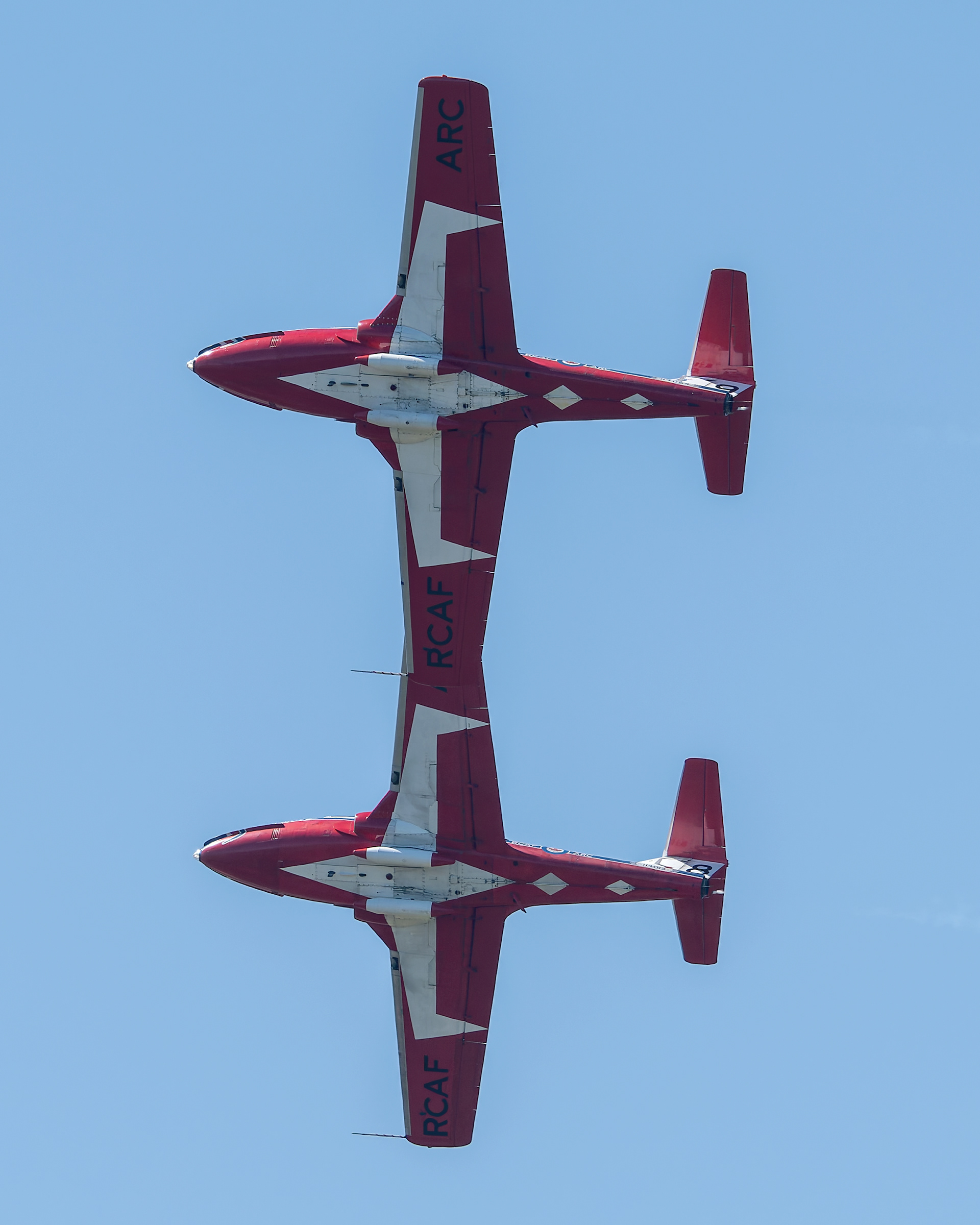The Canadian Forces Snowbirds (431 Air Demonstration Squadron) perform a precision formation flight, leaving signature white smoke trails against a clear sky during their 2026 spring training demonstration over Vancouver Island. Fine art aviation photography by Kevin Prentice.