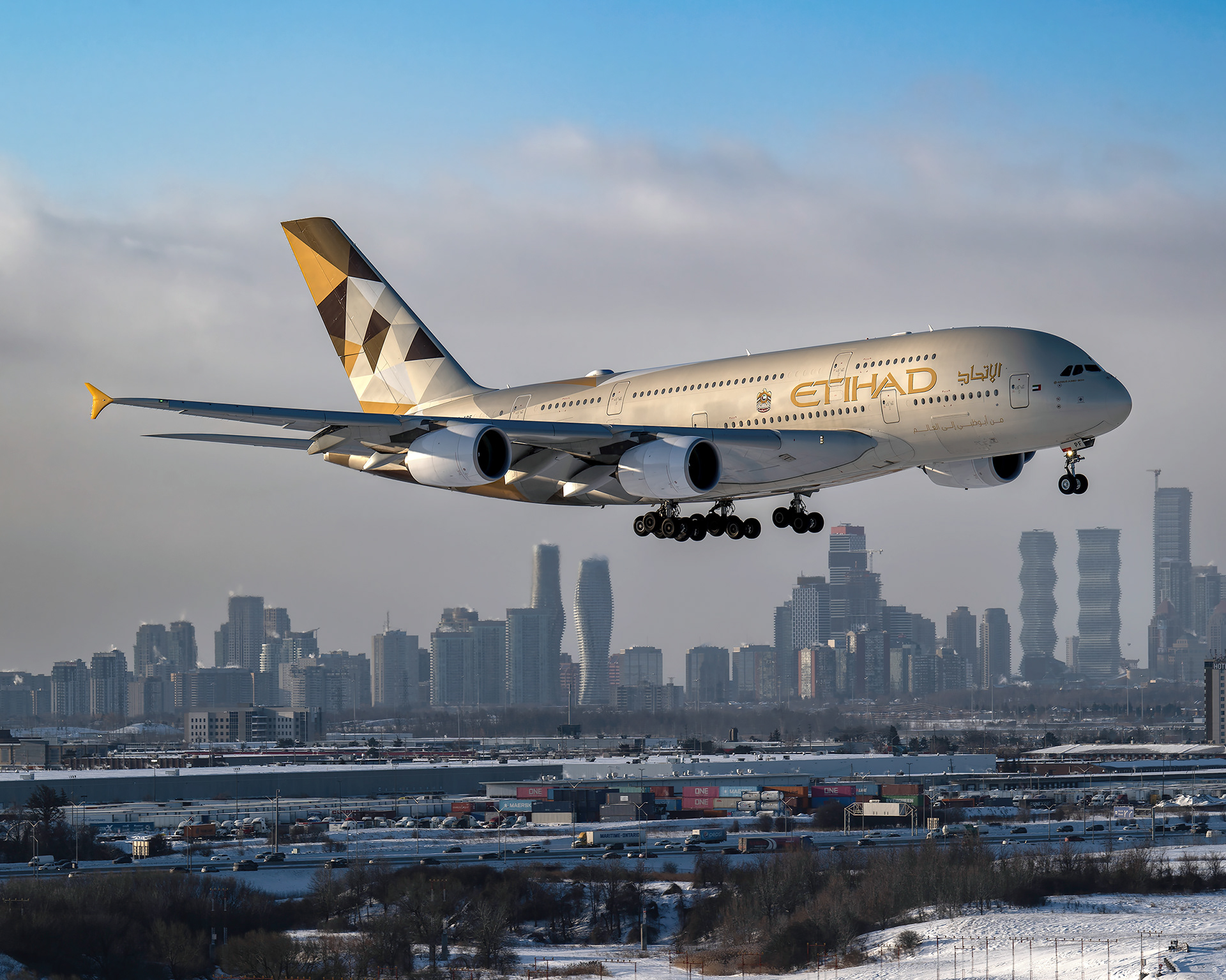 Etihad Airways Airbus A380 superjumbo on final approach to Toronto Pearson International Airport (YYZ) with the iconic Mississauga skyline and Absolute World towers in the background. Commercial aviation photography by Kevin Prentice.