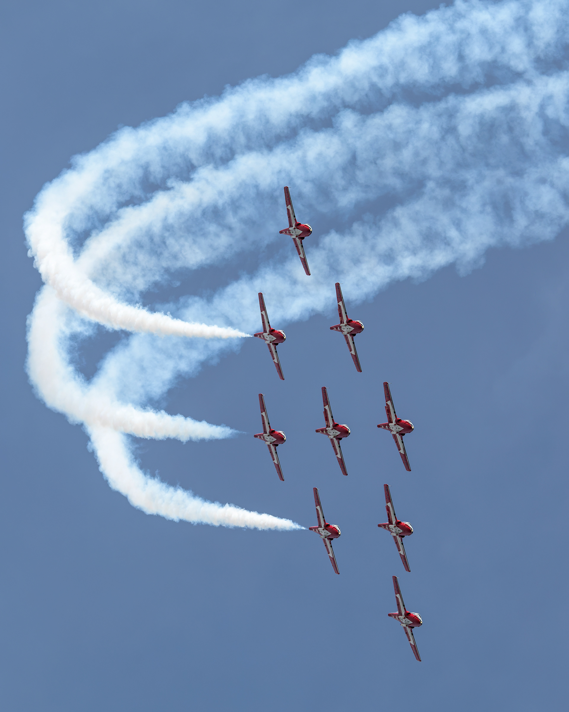 The Canadian Forces Snowbirds (431 Air Demonstration Squadron) perform a precision formation flight, leaving signature white smoke trails against a clear sky during their 2026 spring training demonstration over Vancouver Island. Fine art aviation photography by Kevin Prentice.