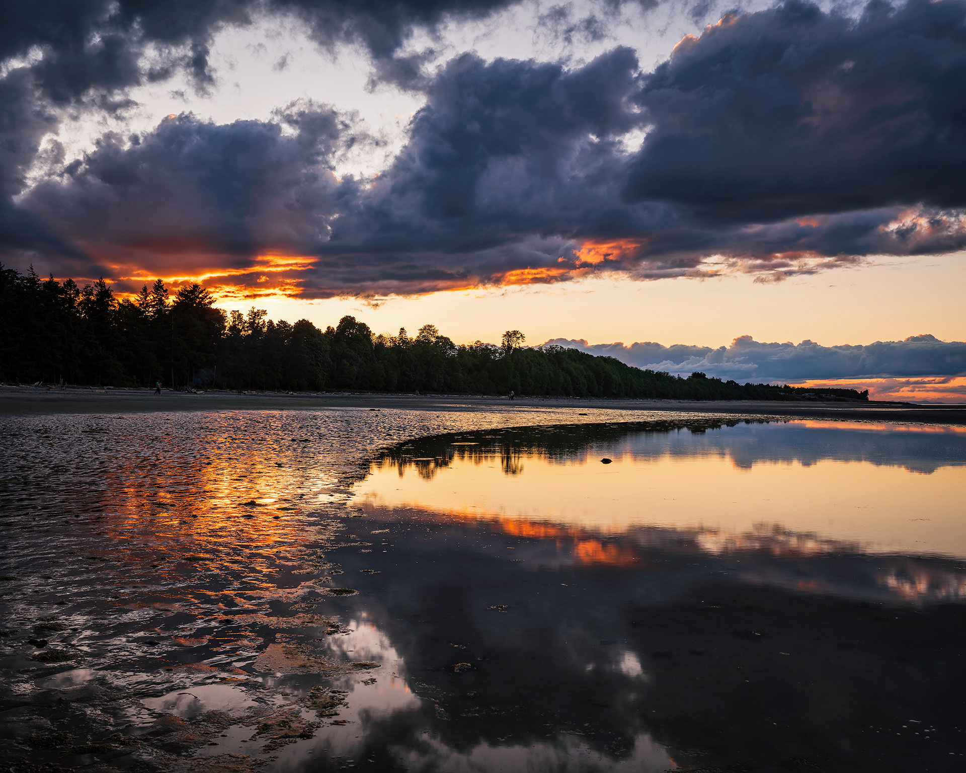 Dramatic sunset skies reflecting perfectly on the calm tidal flats of Kye Bay in Comox on Vancouver Island, British Columbia. Fine art landscape photography by Kevin Prentice.