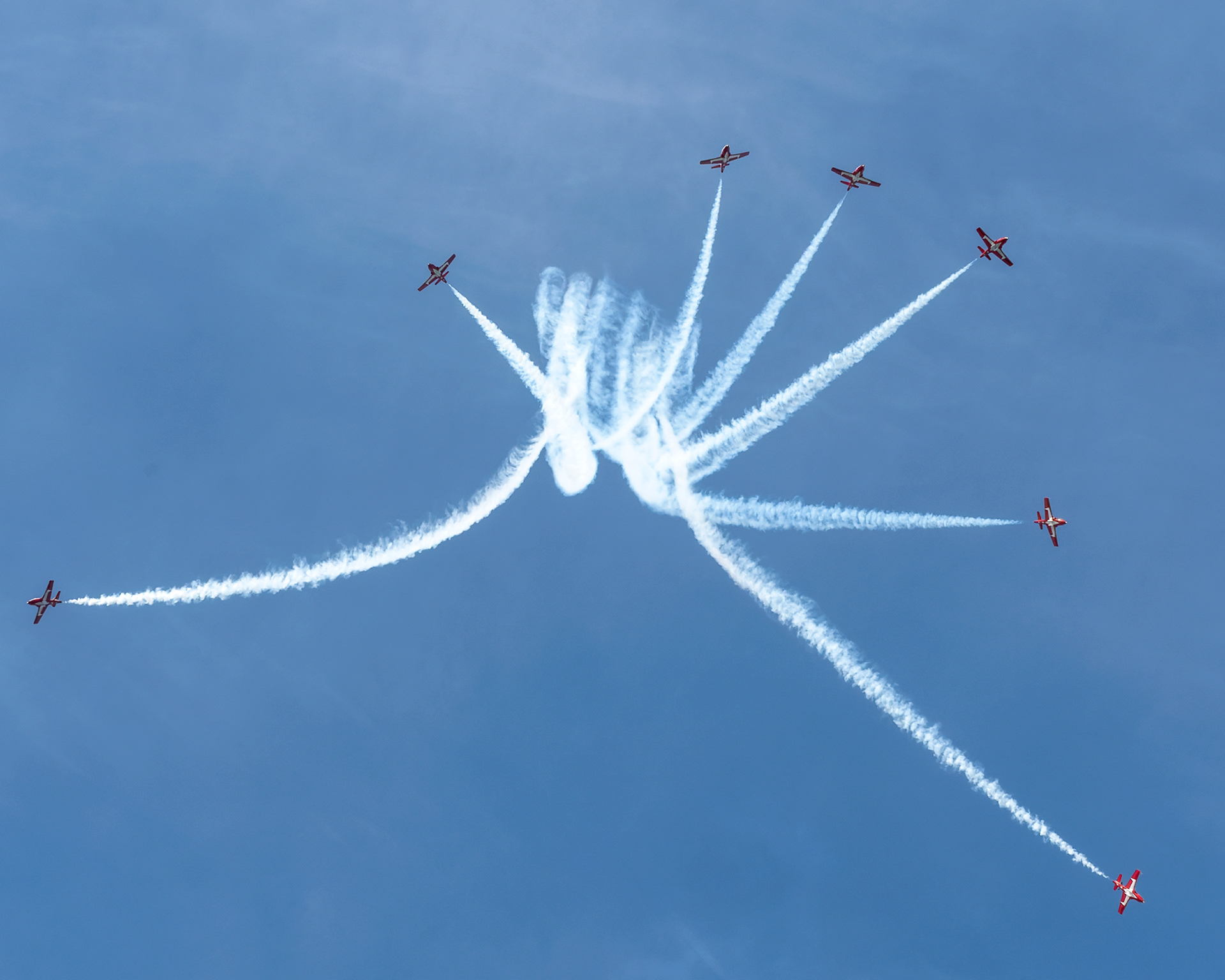 The Canadian Forces Snowbirds (431 Air Demonstration Squadron) perform a precision formation flight, leaving signature white smoke trails against a clear sky during their 2026 spring training demonstration over Vancouver Island. Fine art aviation photography by Kevin Prentice.
