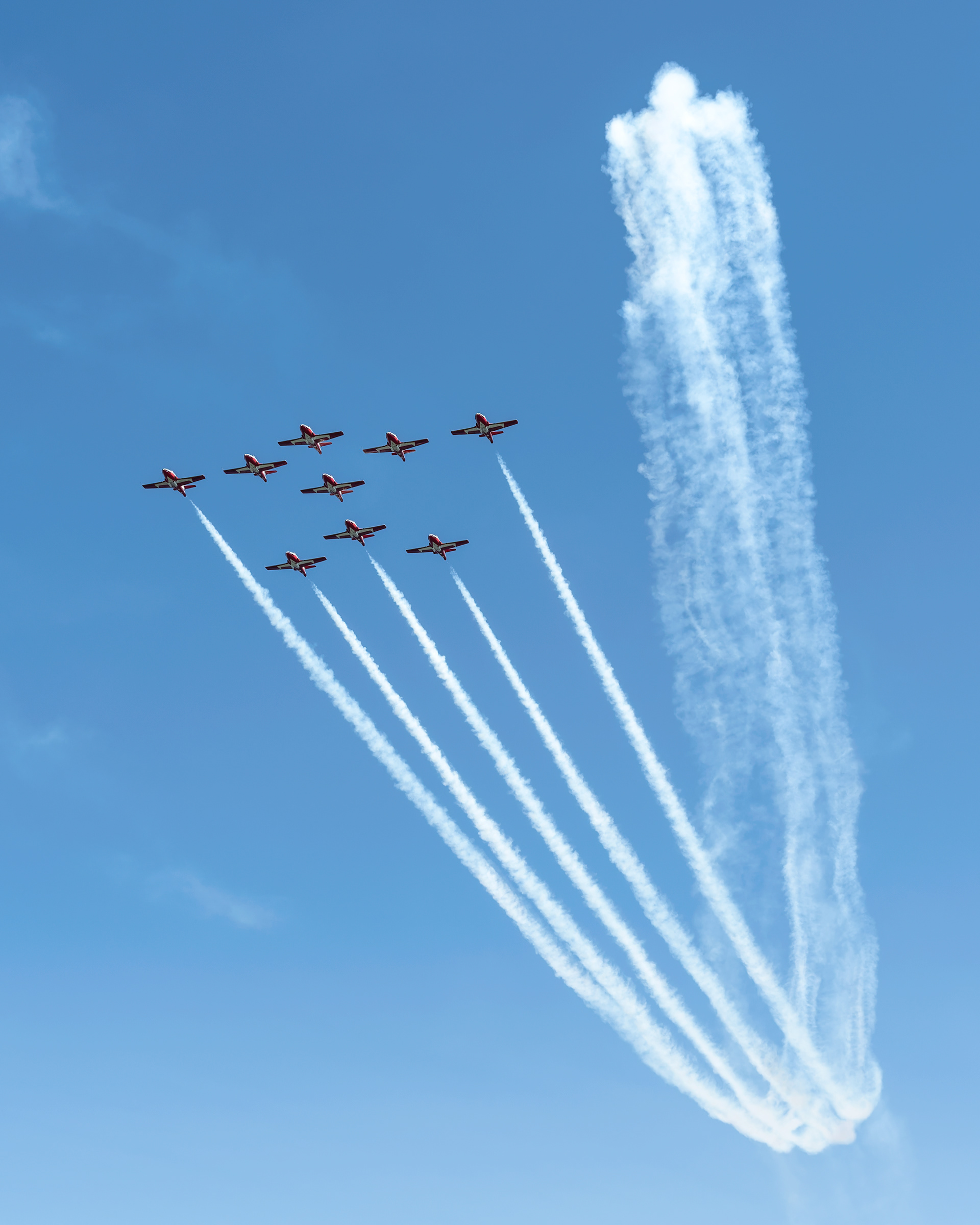 The Canadian Forces Snowbirds (431 Air Demonstration Squadron) perform a precision formation flight, leaving signature white smoke trails against a clear sky during their 2026 spring training demonstration over Vancouver Island. Fine art aviation photography by Kevin Prentice.