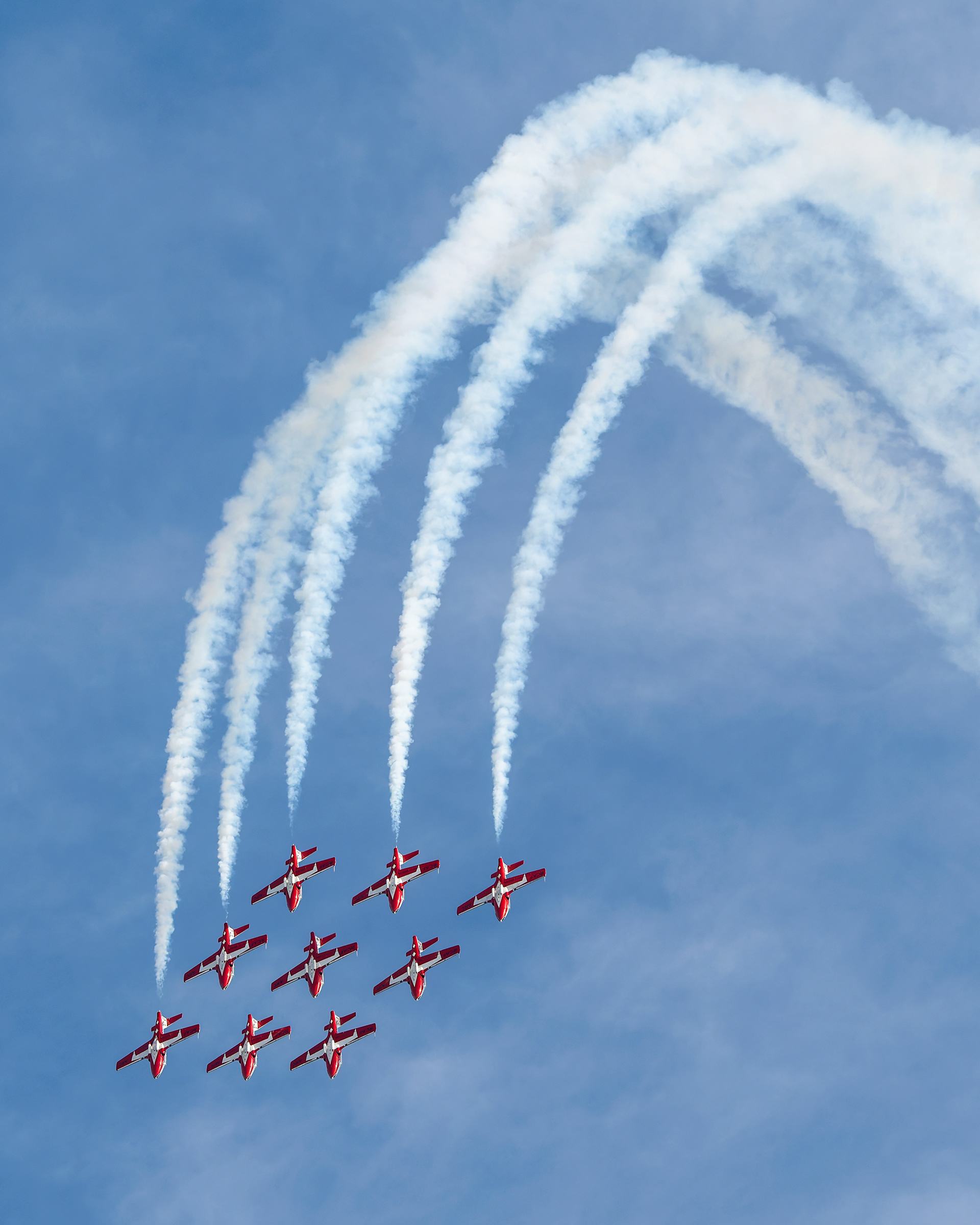 The Canadian Forces Snowbirds (431 Air Demonstration Squadron) perform a precision formation flight, leaving signature white smoke trails against a clear sky during their 2026 spring training demonstration over Vancouver Island. Fine art aviation photography by Kevin Prentice.