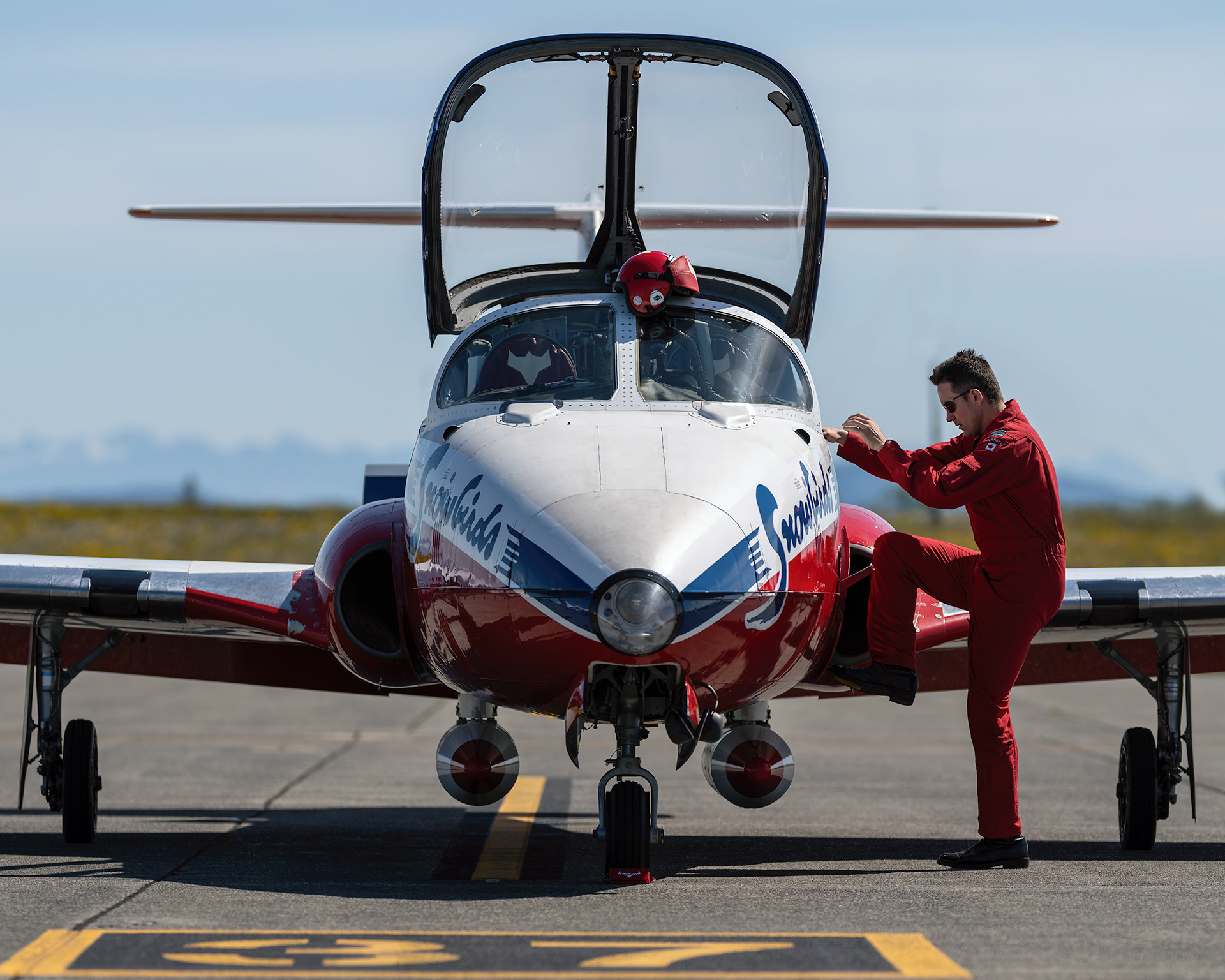 Snowbird 1, Team Lead Major Maciej Hatta, climbs into the cockpit of his CT-114 Tutor jet before a training mission during 2026 spring training at CFB Comox, British Columbia. Fine art aviation photography by Kevin Prentice.