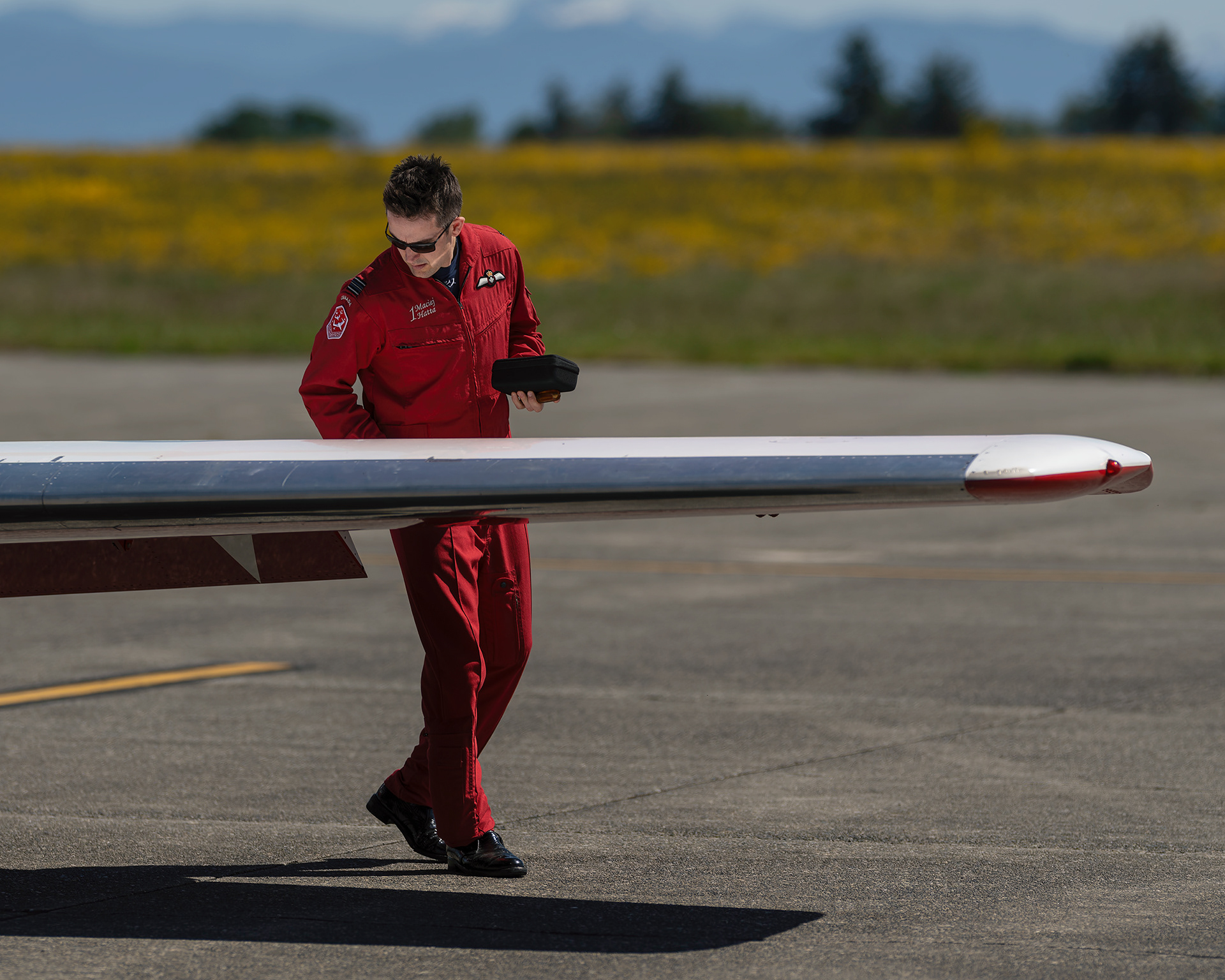 Snowbird 1, Team Lead Major Maciej Hatta, conducts a meticulous pre-flight walkaround inspection of his CT-114 Tutor jet during 2026 spring training at CFB Comox, British Columbia. Fine art aviation photography by Kevin Prentice.