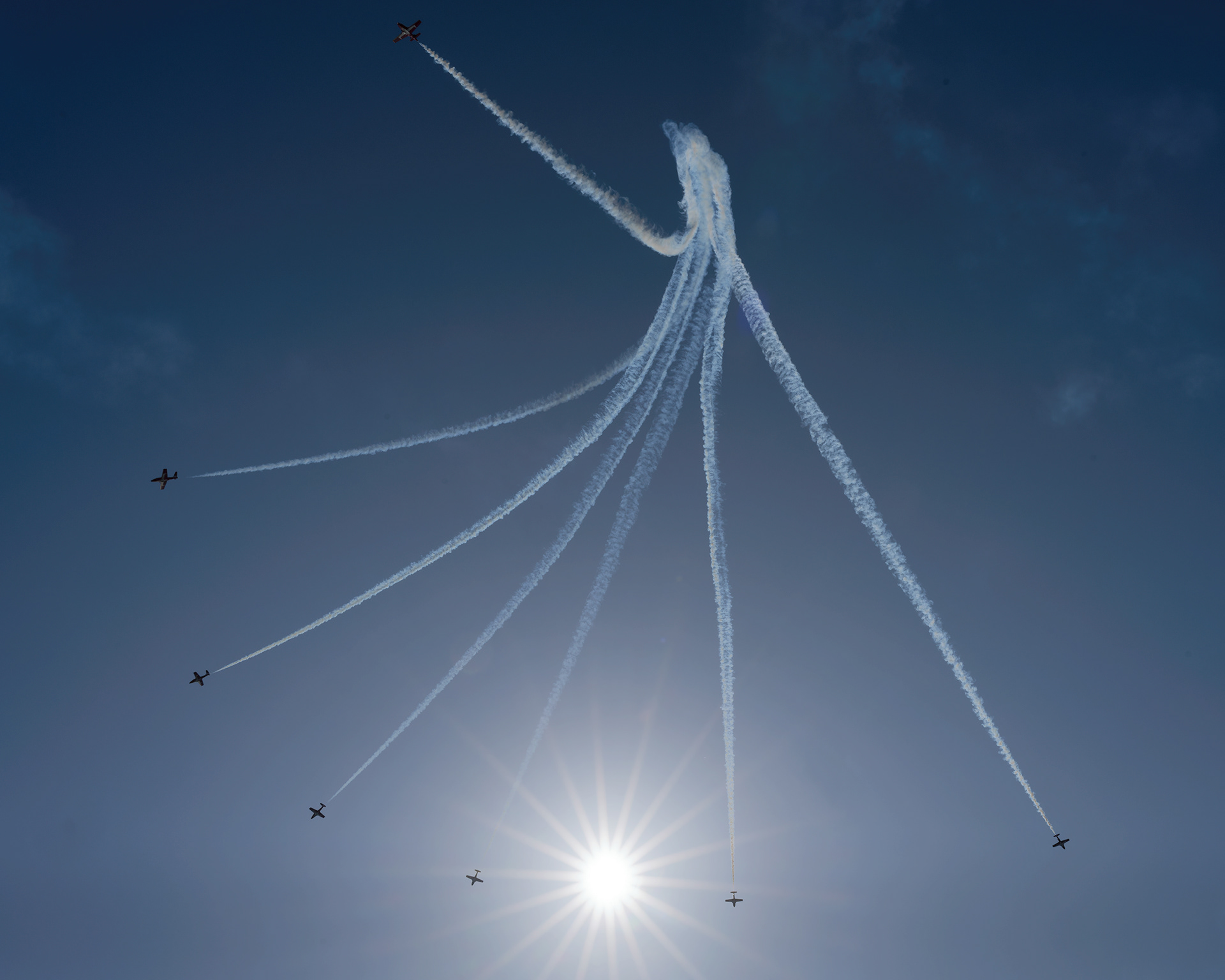 The Canadian Forces Snowbirds (431 Air Demonstration Squadron) perform a precision formation flight, leaving signature white smoke trails against a clear sky during their 2026 spring training demonstration over Vancouver Island. Fine art aviation photography by Kevin Prentice.