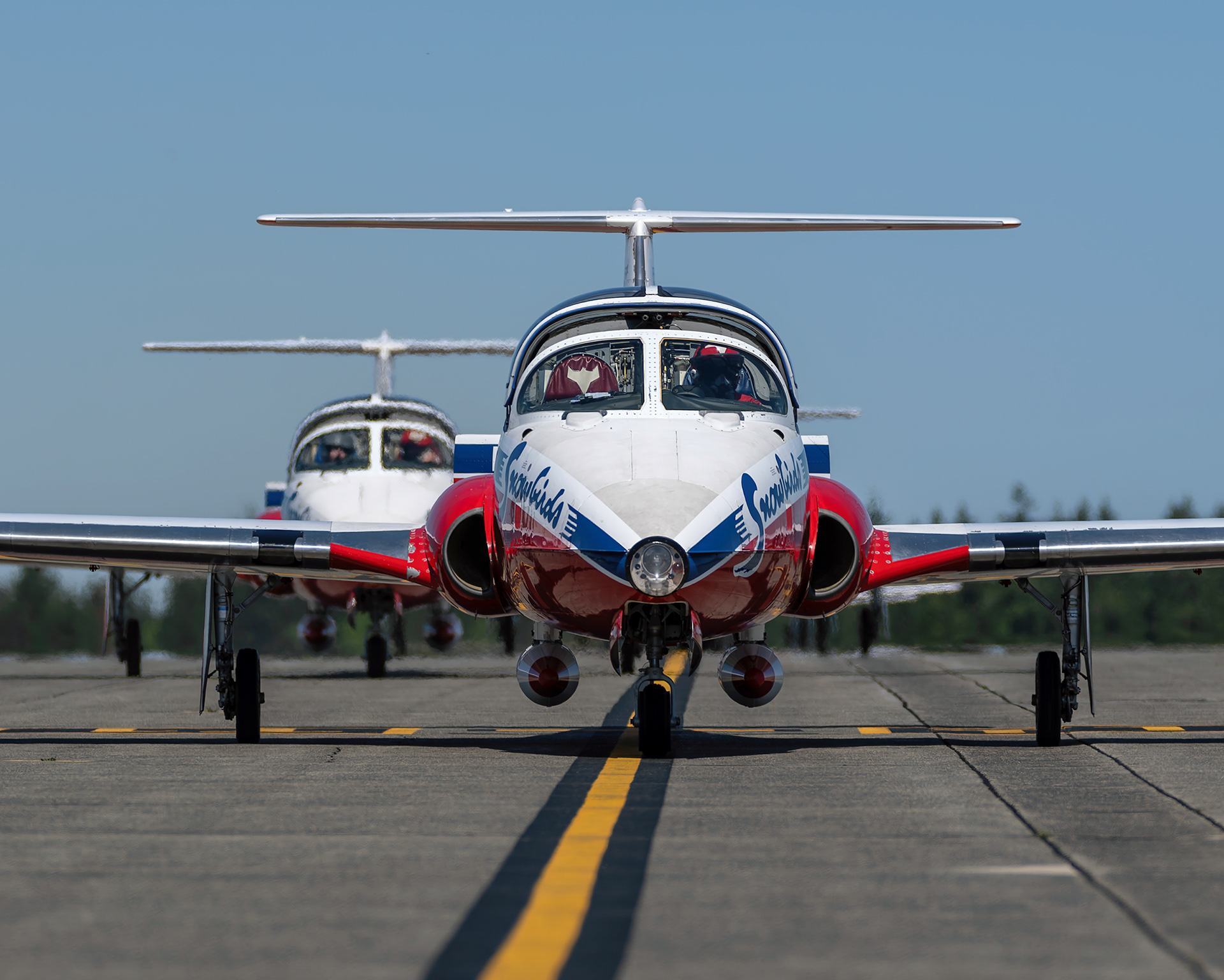 Snowbird 1, piloted by Team Lead Major Maciej Hatta, leads a formation of CT-114 Tutor jets back to the flight line after a practice flight during 2026 spring training at CFB Comox, British Columbia. Fine art aviation photography by Kevin Prentice.