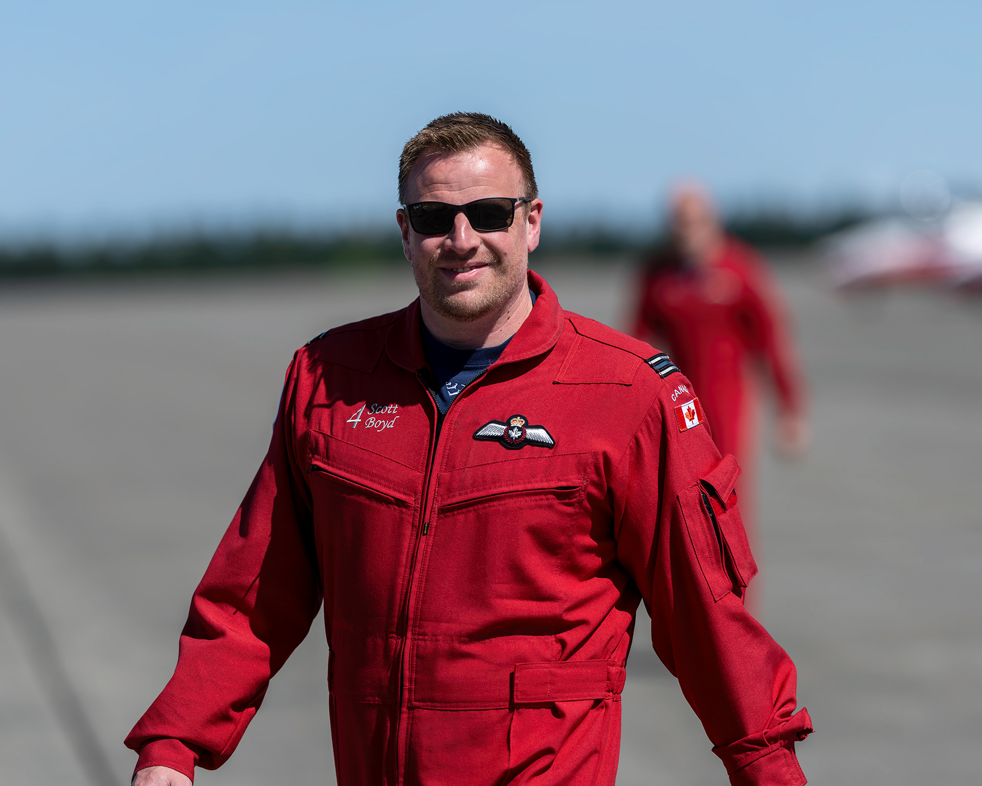 Snowbird 4, pilot Scott Boyd, walks the flight line during the 2026 spring training deployment at 19 Wing Comox, British Columbia. Fine art aviation photography by Kevin Prentice.