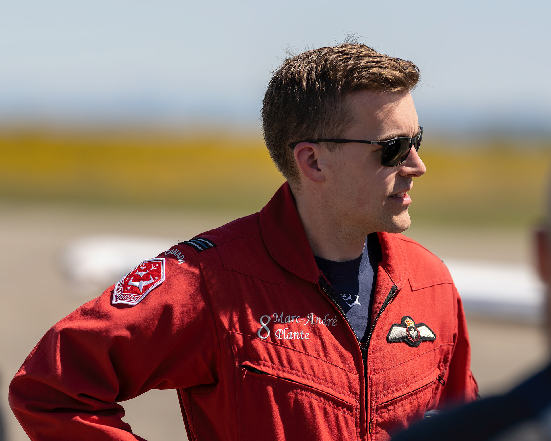 Captain Marc-André Plante, Lead Solo (Snowbird 8), speaking with photographers and media following a high-performance practice session at the 2026 Canadian Forces Snowbirds spring training at CFB Comox, British Columbia. Fine art aviation documentary portrait by Kevin Prentice.