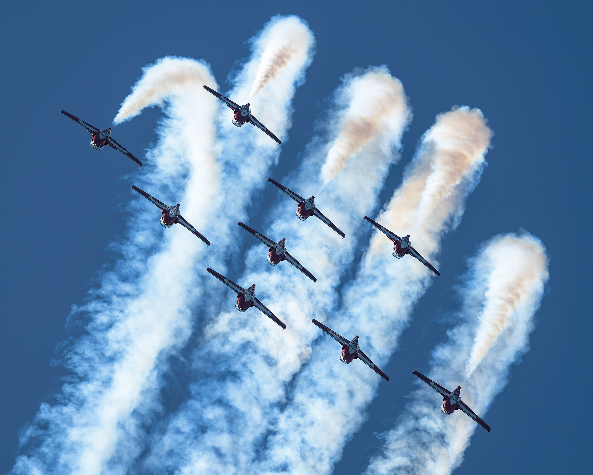 The Canadian Forces Snowbirds (431 Air Demonstration Squadron) perform a precision formation flight, leaving signature white smoke trails against a clear sky during their 2026 spring training demonstration over Vancouver Island. Fine art aviation photography by Kevin Prentice.