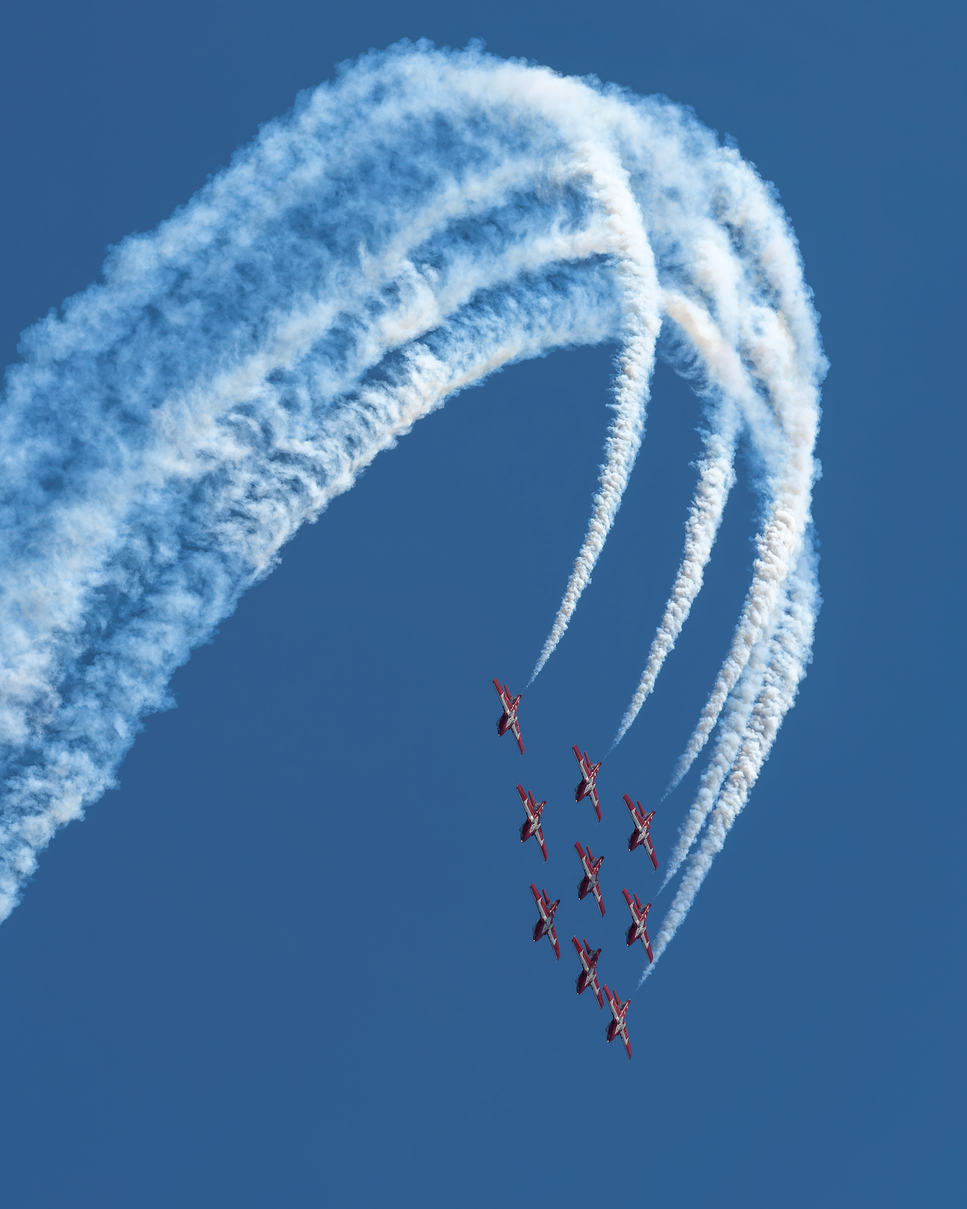 The Canadian Forces Snowbirds execute their signature Big Diamond formation maneuver, leaving dramatic smoke trails against the sky during 2026 spring training at CFB Comox, British Columbia. Fine art aviation photography by Kevin Prentice.