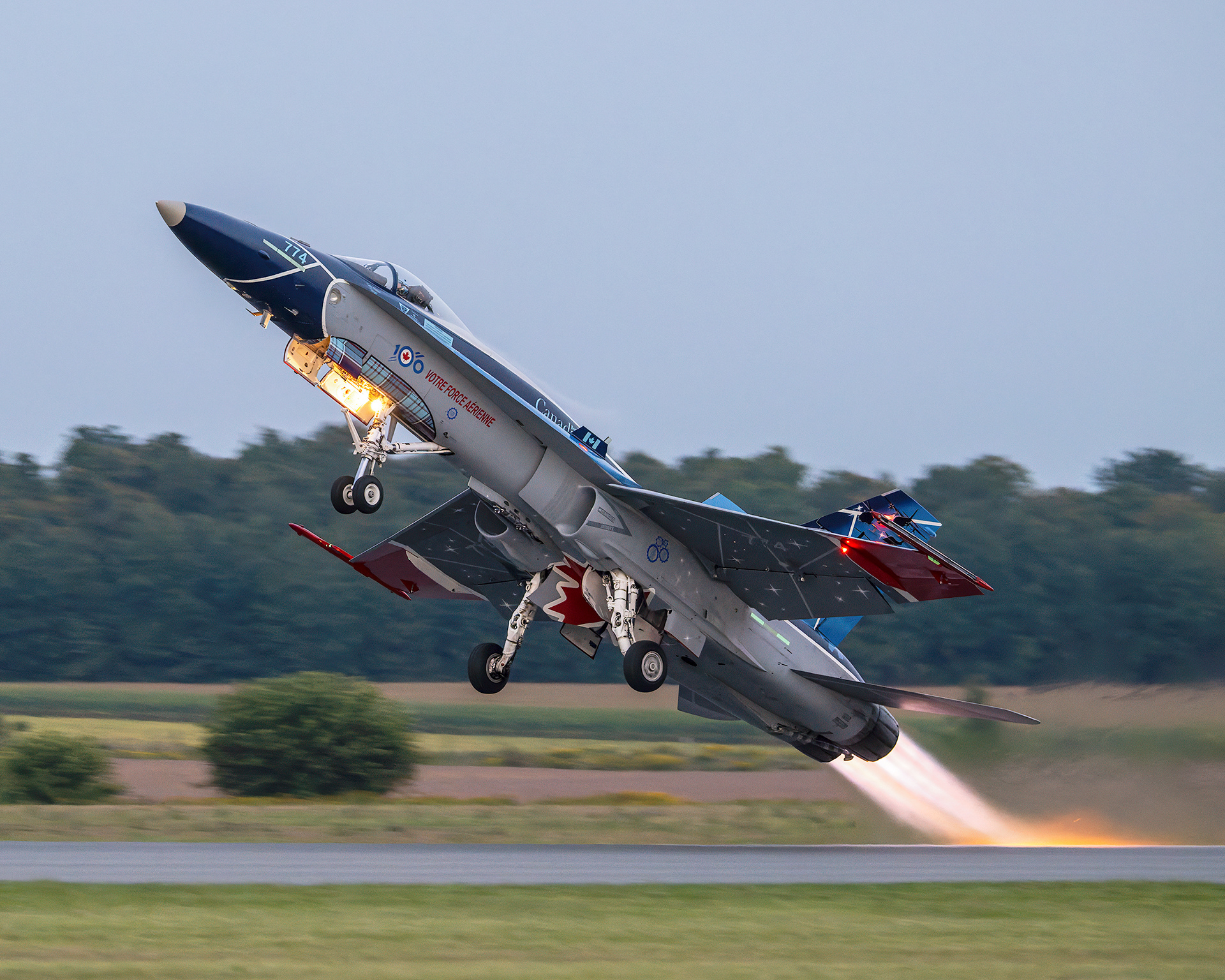 Royal Canadian Air Force (RCAF) CF-18 Hornet 100th Anniversary demonstration fighter jet taking off with afterburners lit. Airshow aviation photography by Kevin Prentice.