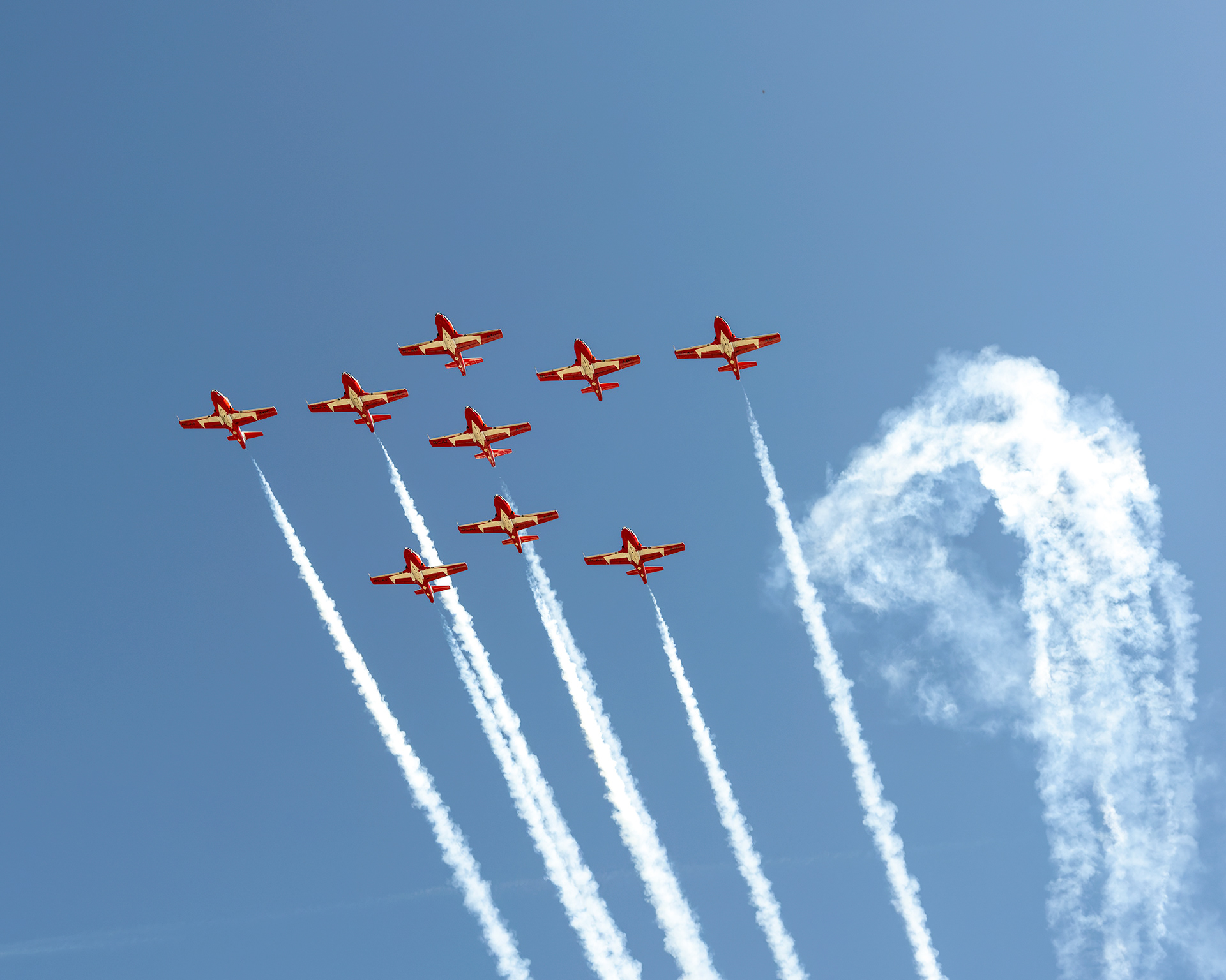 The Canadian Forces Snowbirds (431 Air Demonstration Squadron) perform a precision formation flight, leaving signature white smoke trails against a clear sky during their 2026 spring training demonstration over Vancouver Island. Fine art aviation photography by Kevin Prentice.