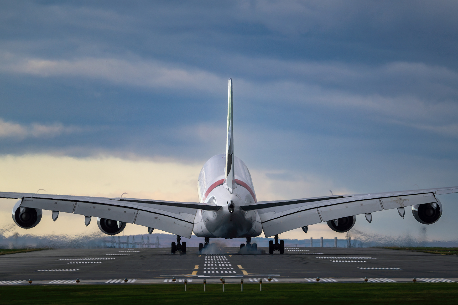 An Emirates Airbus A380 creates a crisp puff of tire smoke during a rear-view touchdown at Toronto Pearson International Airport (YYZ). Captured on October 20, 2025. Commercial aviation photography by Kevin Prentice.