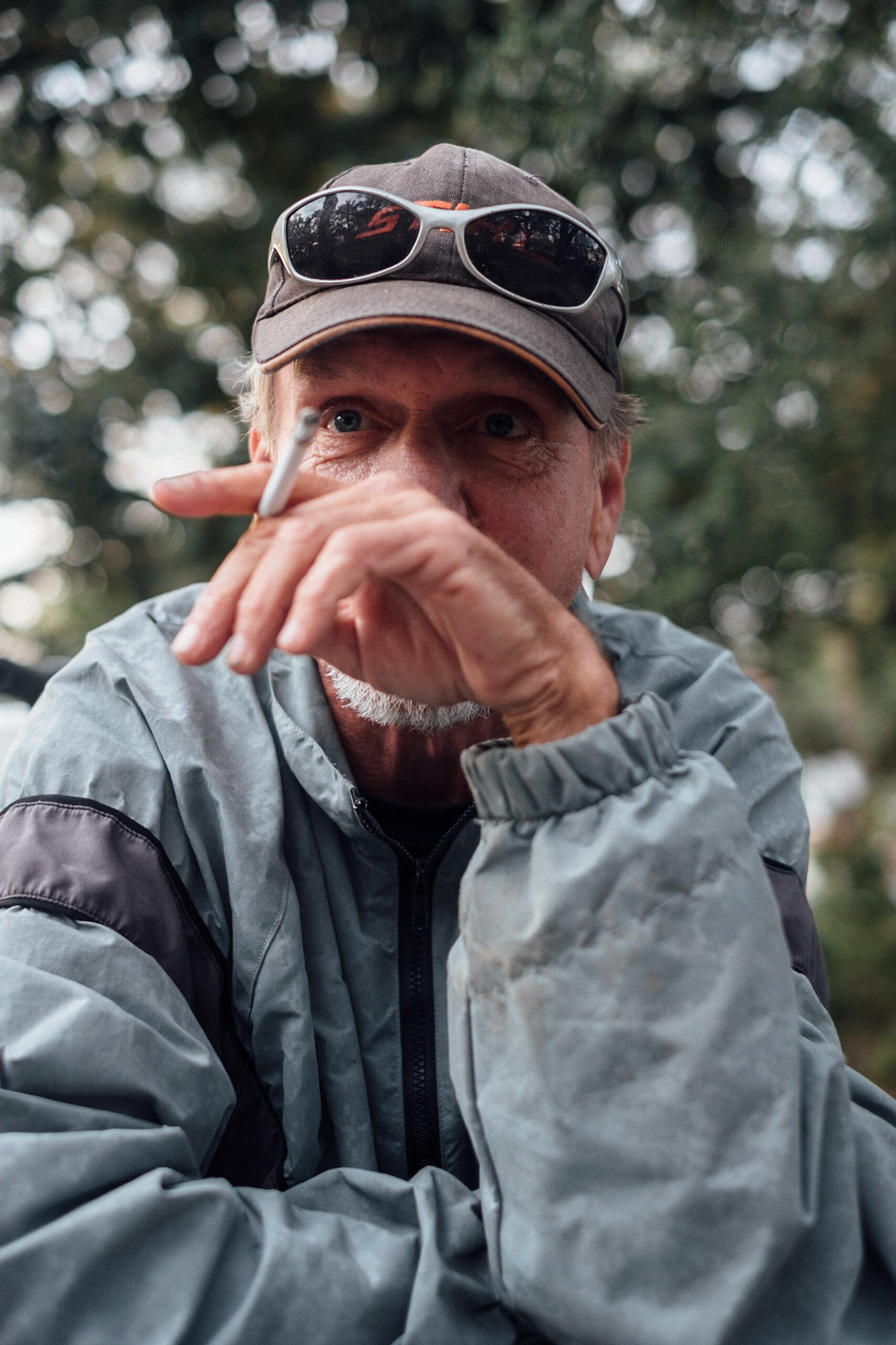 (Mostly) Bicycling America XXVII. Three Portraits in New Orleans, 2018, I. This guy was hanging out at a park near my buddy's apartment I was staying at for the week I was here. I just wandered by and he started talking to me. Might have had something to drink. Definitely had something to drink, now that I think back (and look at another picture of his Port of Call cup). Pack of Newports and a flip-phone on the picnic table. I don't remember what we talked about. Mostly I stopped so that I could take some photographs. That's always tricky because sometimes these guys don't want to let you go, and they'll just ramble on about nothing for ages, which is what this guy did. Eventually I just made a break for it though. Said I had somewhere to be, or something to do. He was nice enough, but you gotta do what you gotta do. I really like this photograph.
