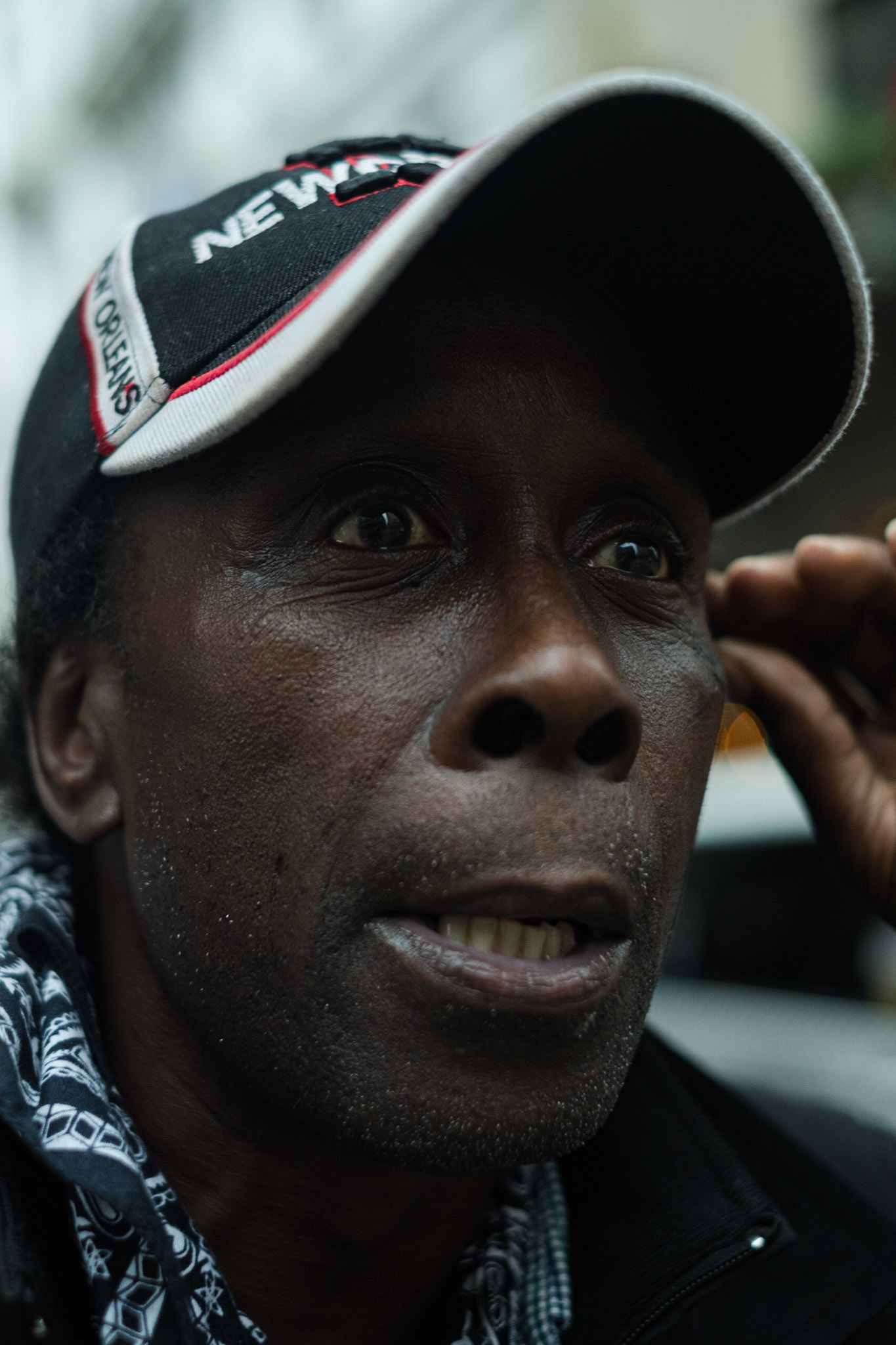 (Mostly) Bicycling America XXX. Three Portraits in New Orleans, 2018, III. This guy was definitely a bit out there. Homeless? Maybe. He was approaching different people along Royal St. looking for money or food. I asked him where we might go to get him something and he said there was a Subway and a McDonald's across the intersection we were at. I asked him too if he didn't mind me snapping a few photos of him, to which he replied in the affirmative. The little bugger wouldn't stop moving around though! He was like a damn bobble-head the way he kept moving his head up and down, looking here and there, always on the lookout, for God only knows what; I don't think he even knew what he was doing.  I somehow managed to get this shot, eyes, those crazy intense one-pointed eyes, in focus miraculously, but not before he asked me when I was going to stop taking pictures of him. It was after this that we wandered slowly over, he had a weird sort of limp, and couldn't move very quickly, I got him his sub, and left him bothering someone else in his bitter casustic way of approaching people.