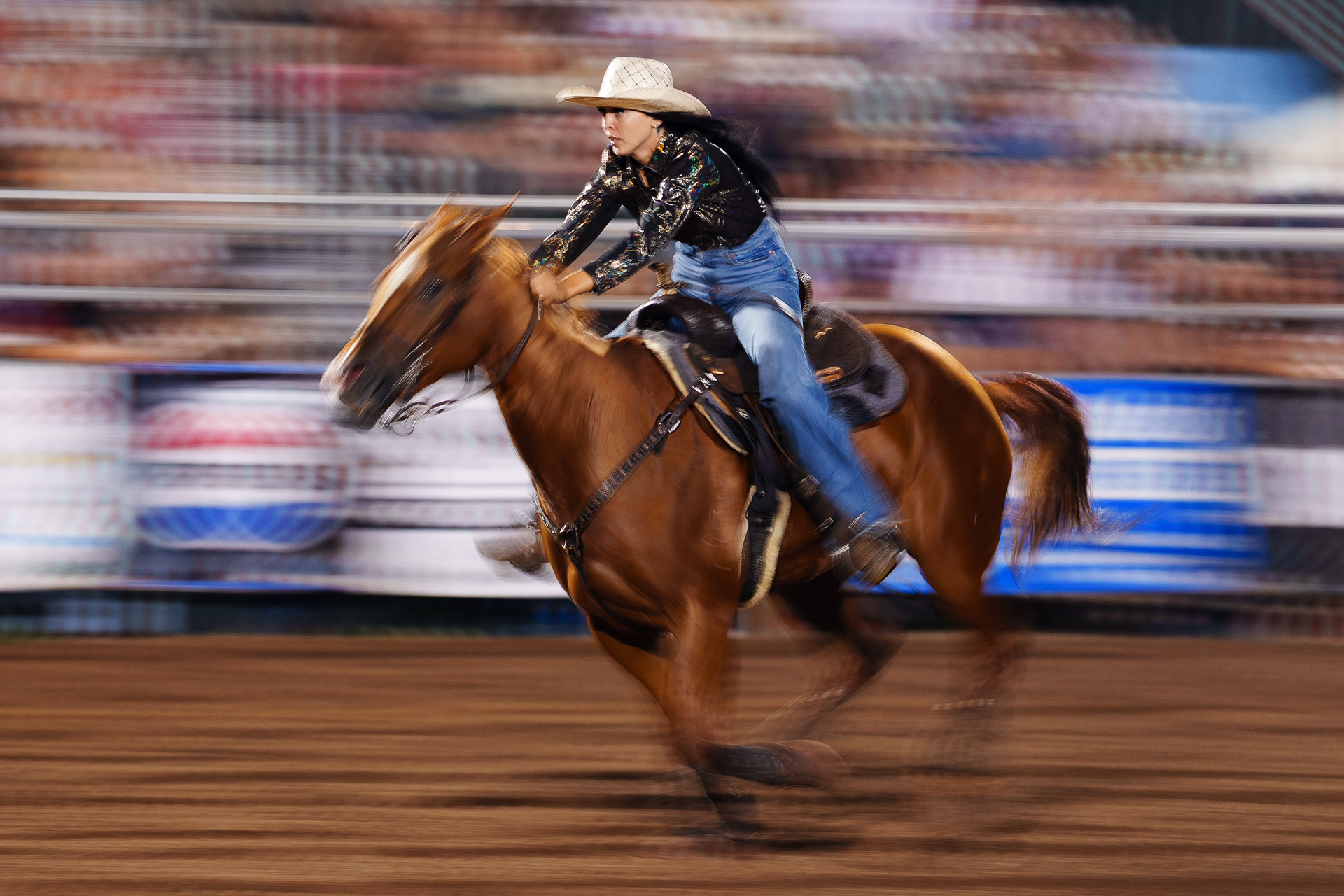 A barrel racer races across the arena during the Benton Frontier Days Rodeo in Benton, Pa.