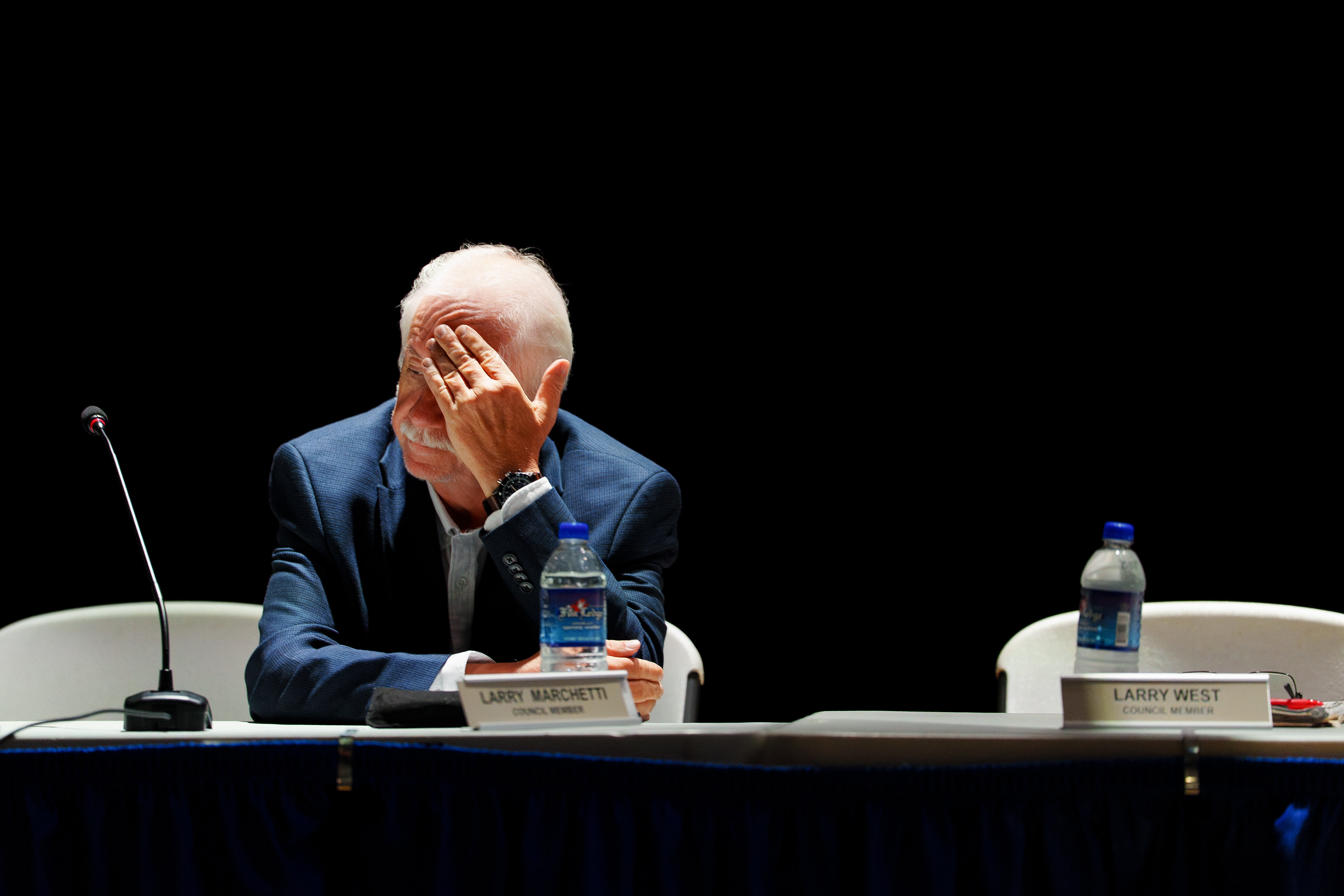 Council Member Larry Marchetti covers his face with his hand during a public hearing on the proposed Wildcat Ridge Data Center Campus at Valley View High School in Archbald, Pa.