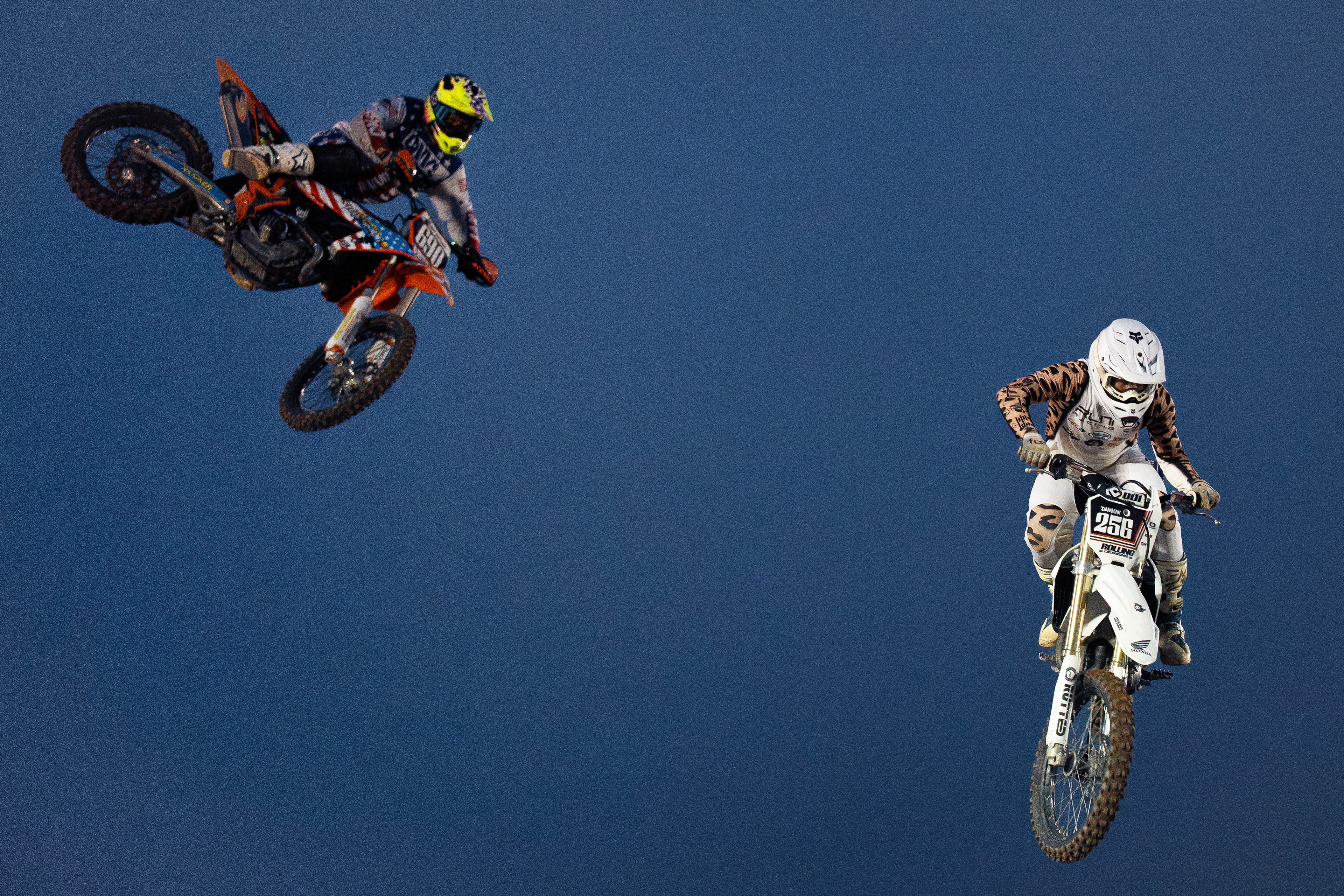 Freestyle motocross riders with Steel Rodeo perform aerial tricks during the Benton Frontier Days Rodeo in Benton, Pa.