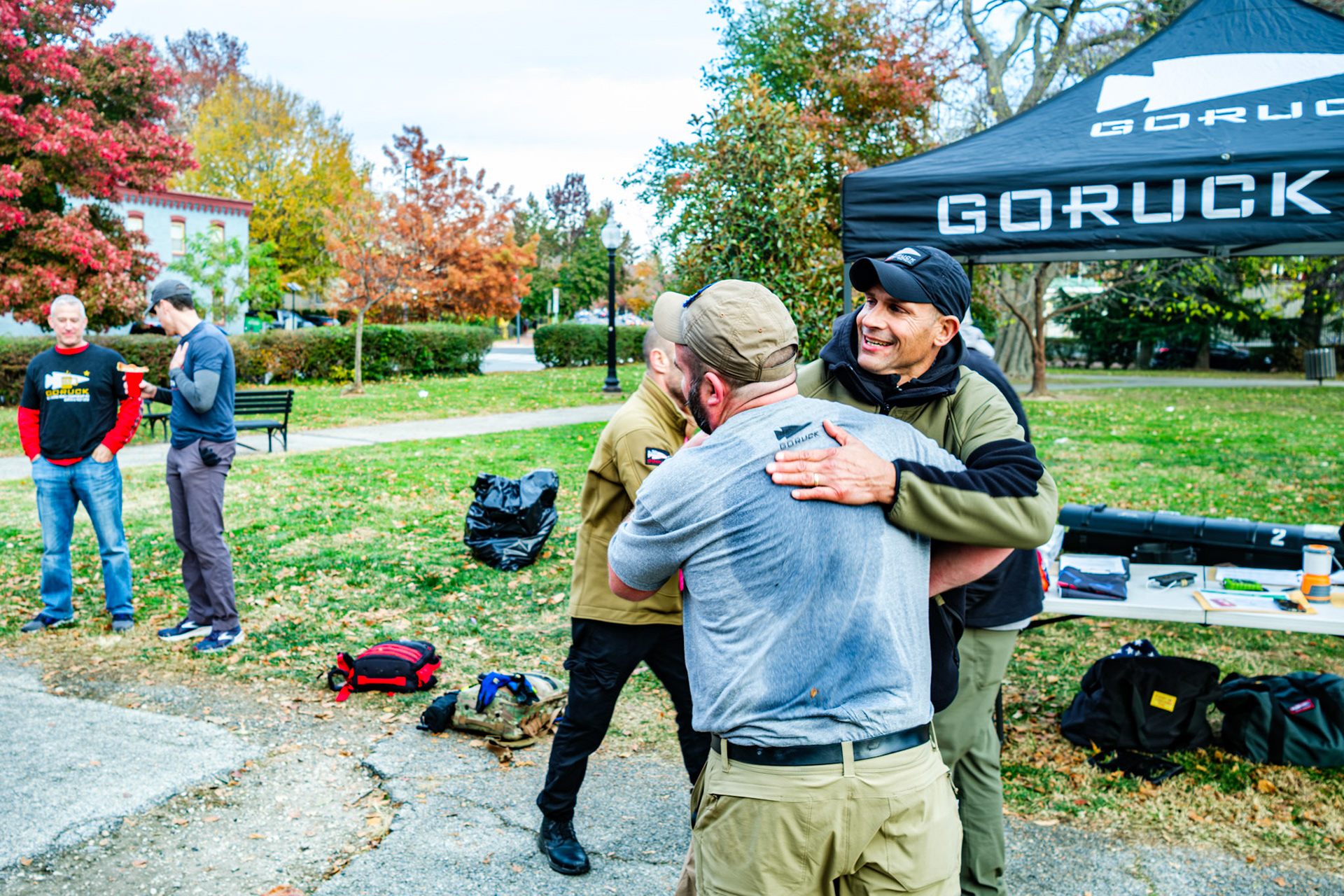Race participant being embrace by Cadre Mocha after finishing the race