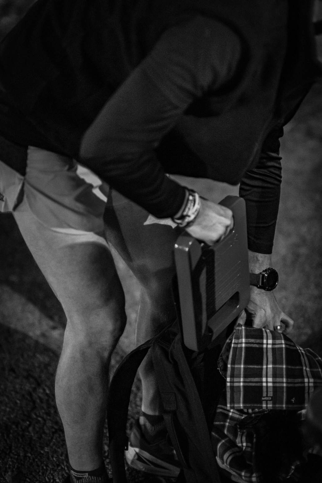 Participants show the event staff that they have the required weights in their ruck