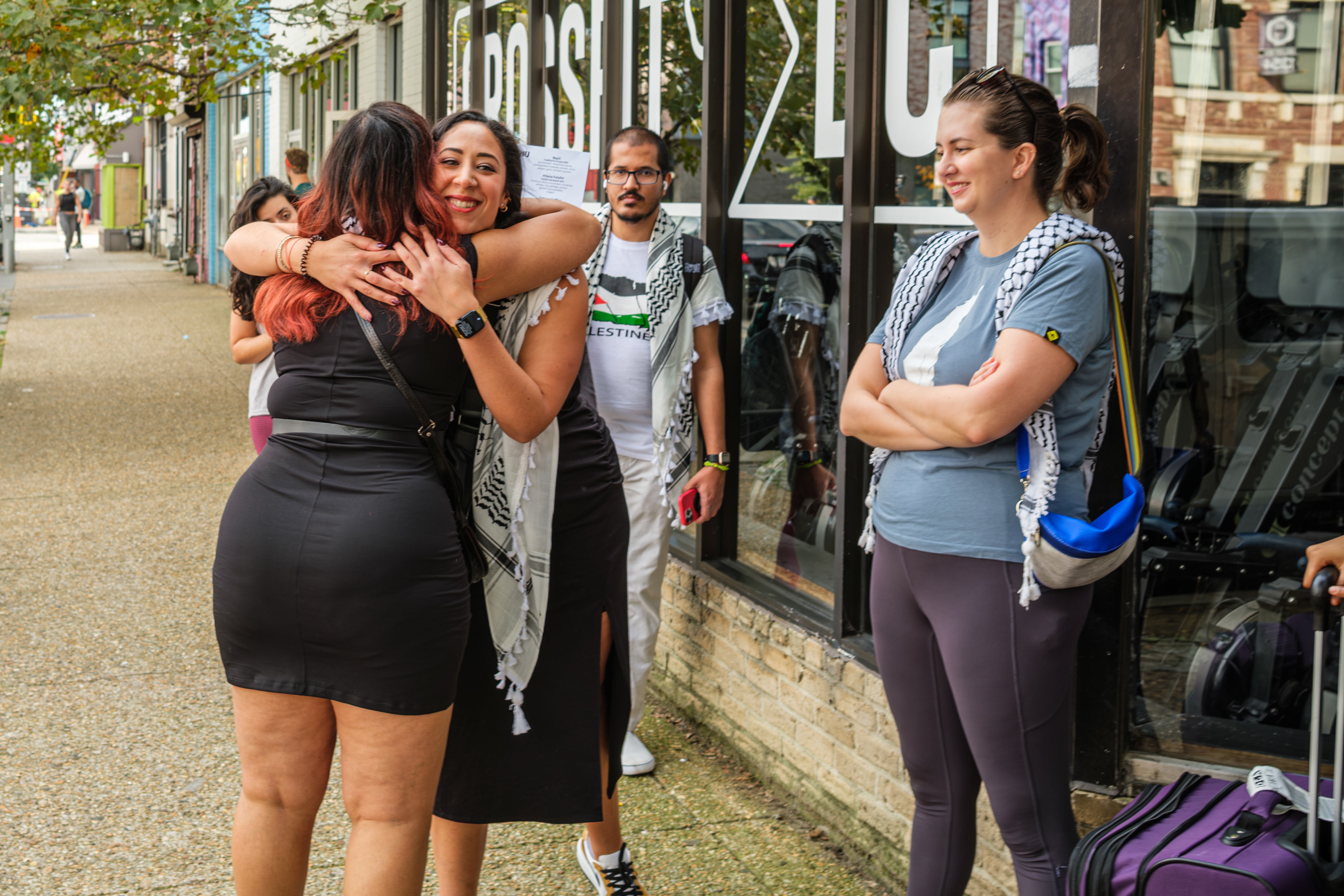 Jinan Deena embracing someone in line