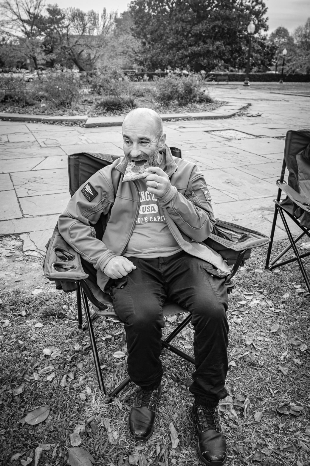 Participant sits down after completing 50 mile ruck and eats
