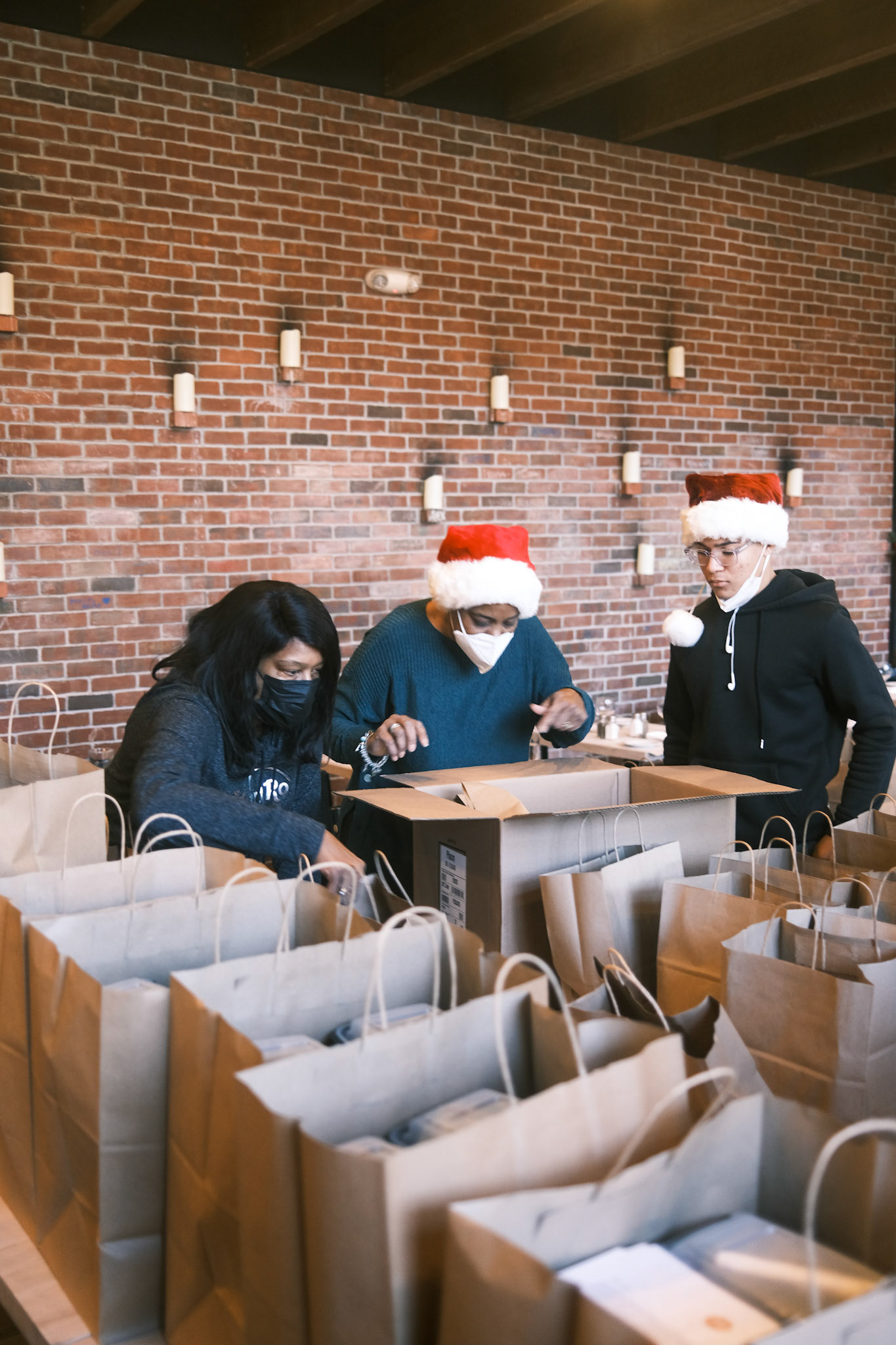 volunteers assembling individual meals as well as boxes of 10 for larger sites