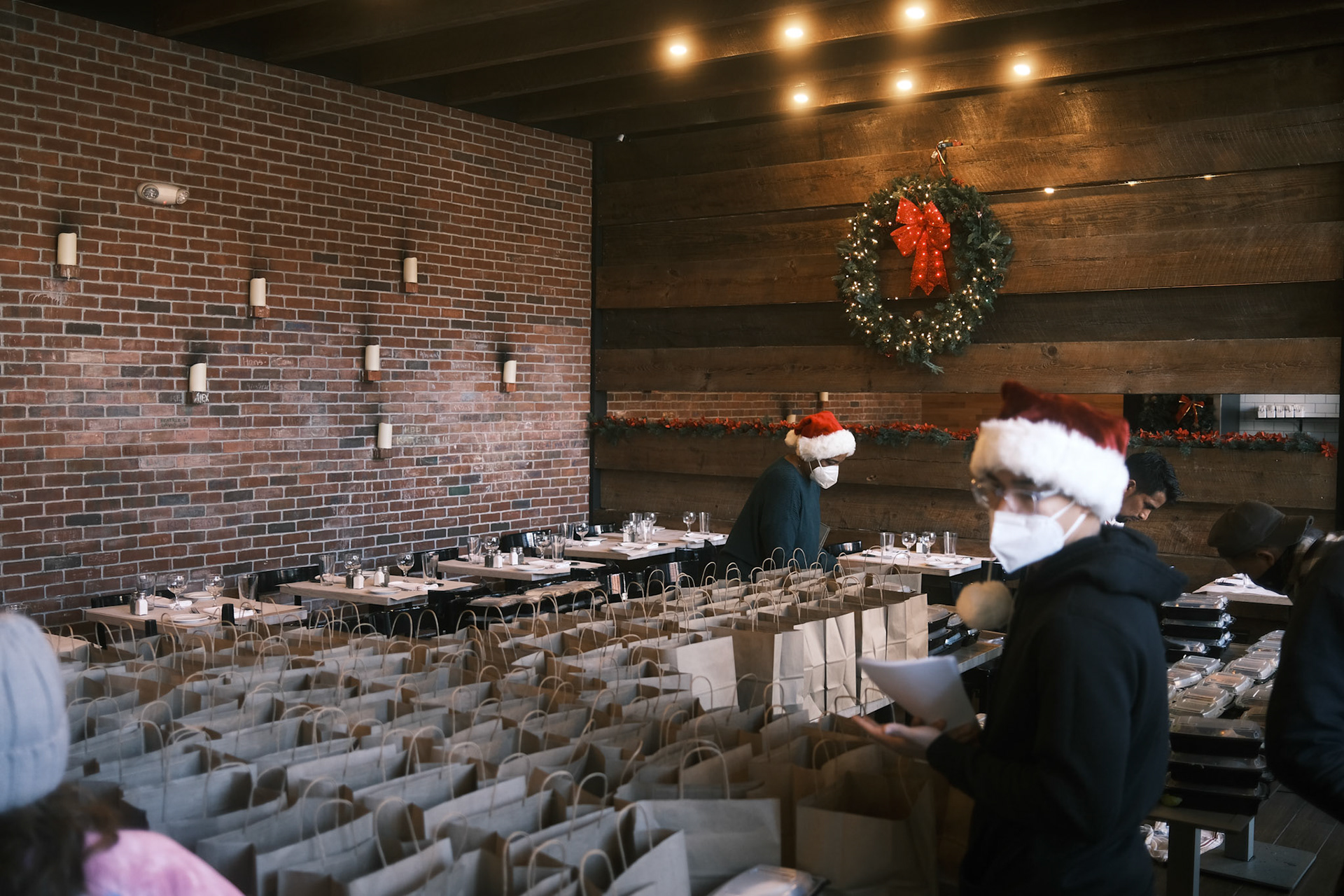 volunteers work to organize meals