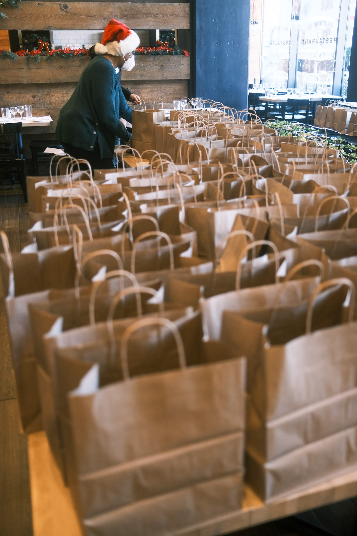 volunteer preparing individual meals for delivery
