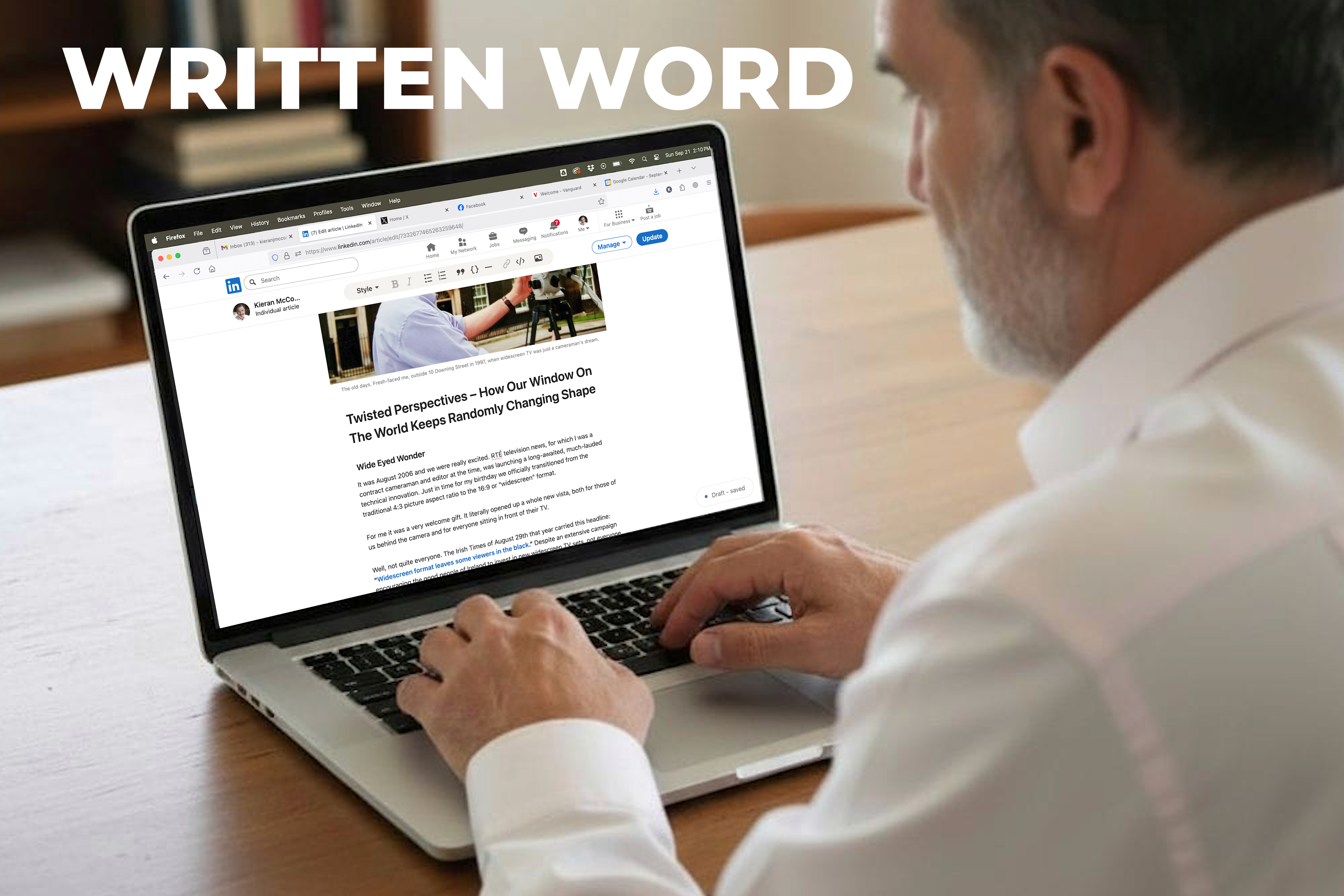 An image of Kieran McConville writing on a laptop
