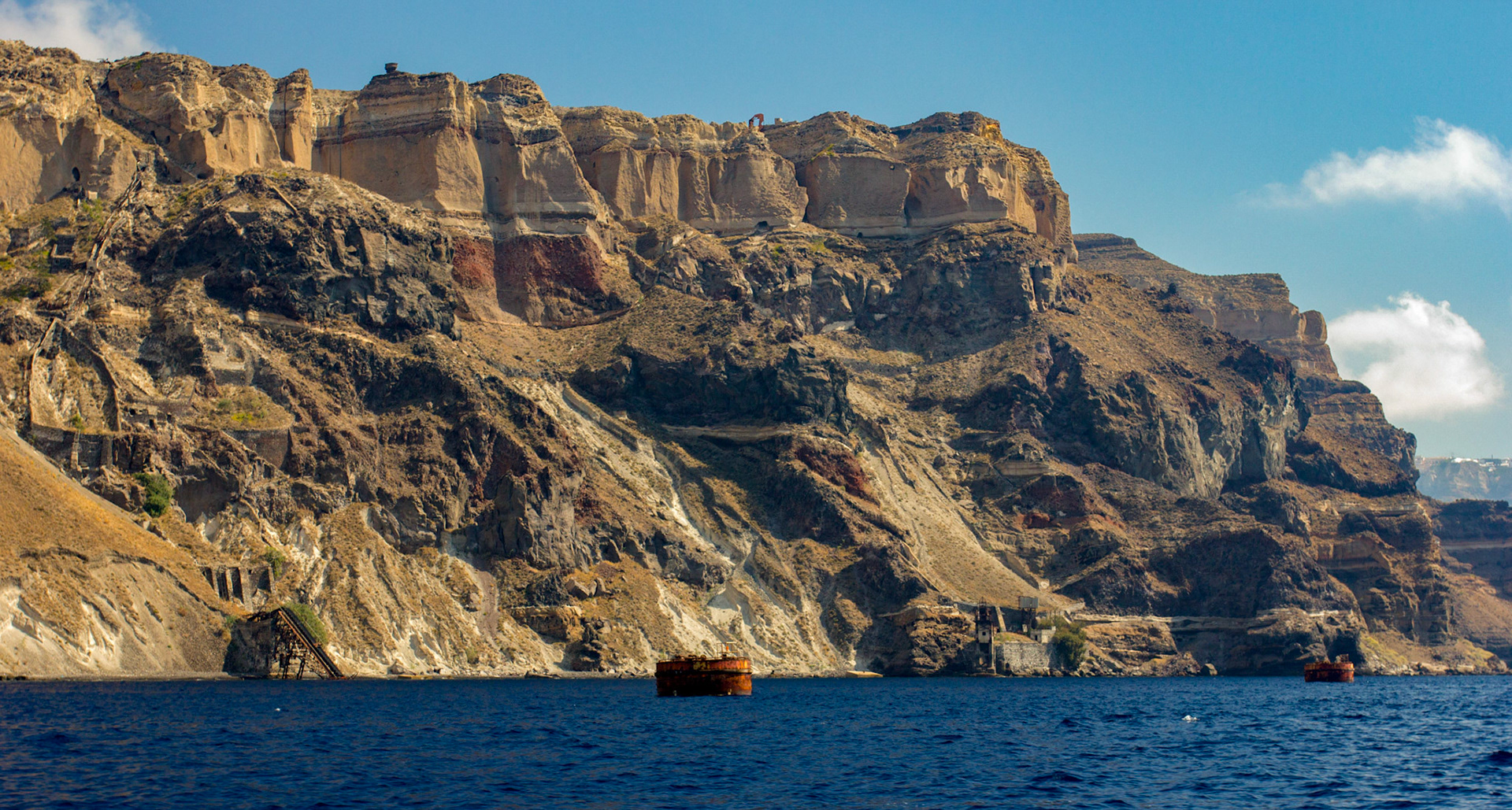 There's been iron ore working on Santorini for a long time, I don't think there's an active mine now. There's some old equipment left behind on the cliffs, and in the sea.