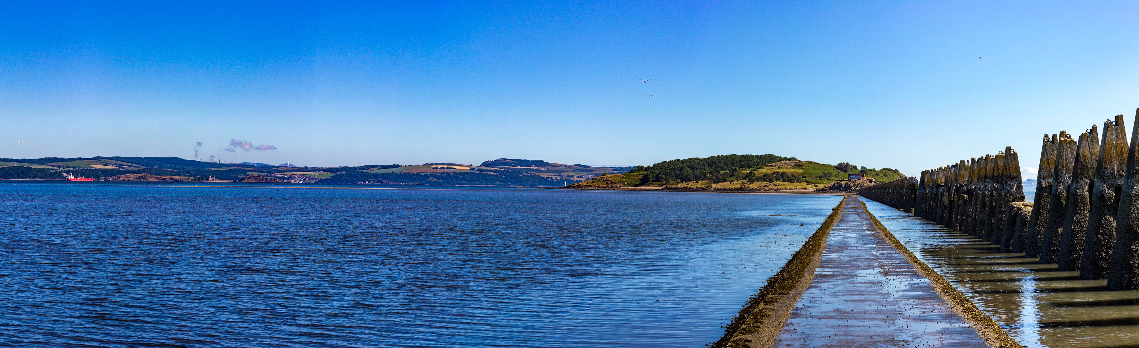 WW1 antisubmarine boom that extended from Cramond to Cramond Island to stop German submarines coming into a safe anchorage between here and the Forth Bridge. It also helped protect Rosyth. An antisubmarine net also extended from Cramond Island to Inchmickery, for the same purpose. Both islands were armed. In WW2 the boom was utilised again, this time with nets extending all the way from Cramond Island to Inchcolm and thence on to Fife. This closed the entire estuary to submarines and fast attack craft. Rosyth was too valuable a target. Please see my other Photographs at: http://www.jamespdeans.co.uk/
