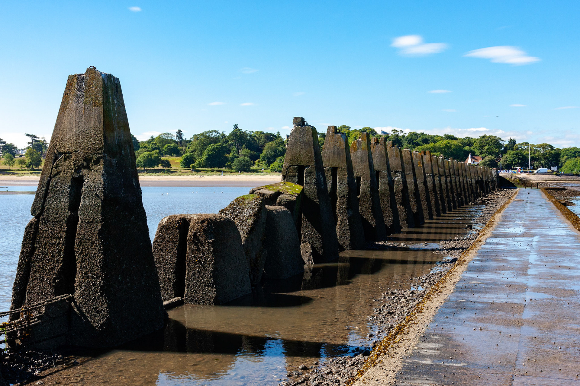 WW1 antisubmarine boom that extended from Cramond to Cramond Island to stop German submarines coming into a safe anchorage between here and the Forth Bridge. It also helped protect Rosyth. An antisubmarine net also extended from Cramond Island to Inchmickery, for the same purpose. Both islands were armed. In WW2 the boom was utilised again, this time with nets extending all the way from Cramond Island to Inchcolm and thence on to Fife. This closed the entire estuary to submarines and fast attack craft. Rosyth was too valuable a target. Please see my other Photographs at: http://www.jamespdeans.co.uk/