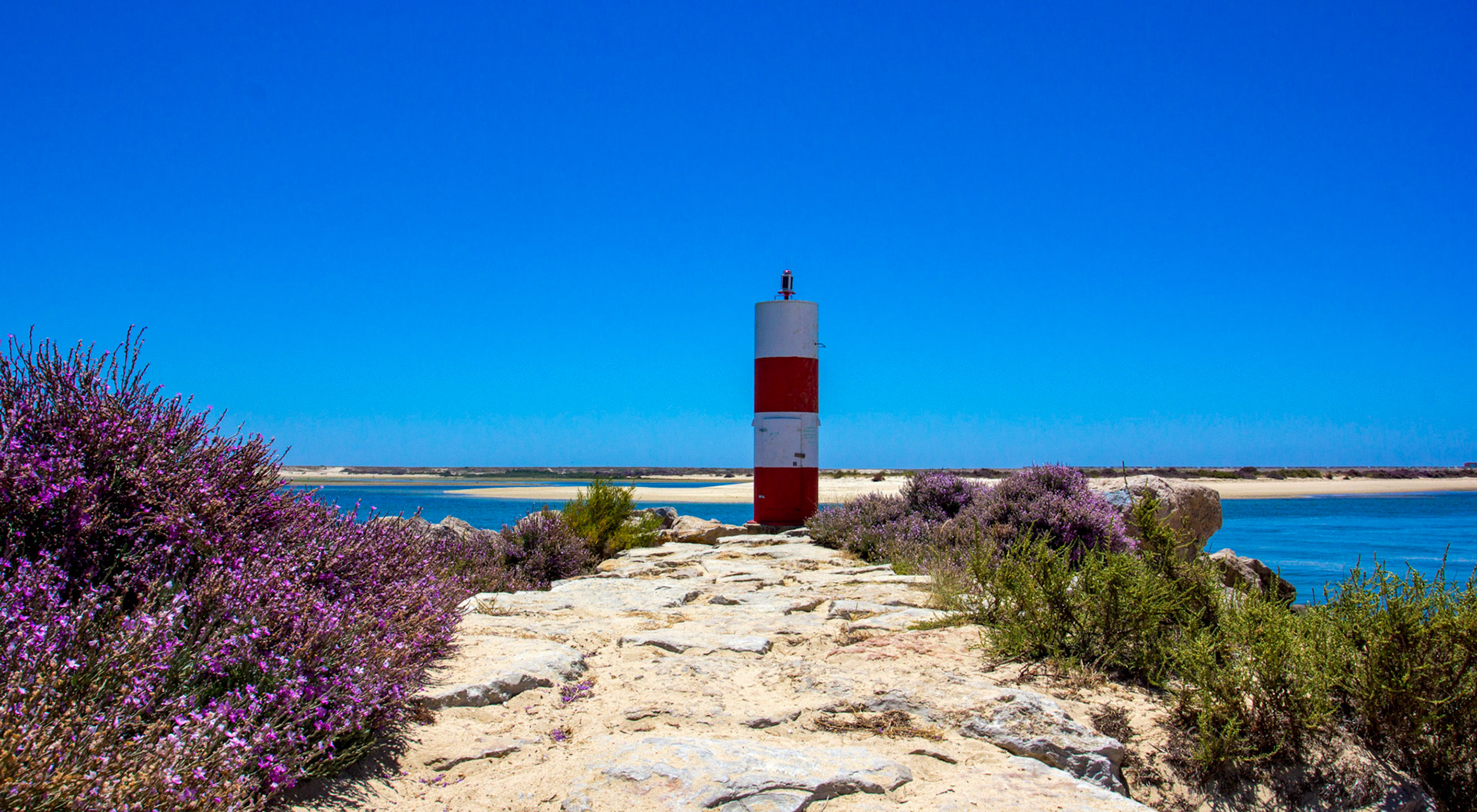 Fuzeta - one of the navigation lights on the way into Fuzeta harbour. I watched a small craft going out at low tide, the route through the sand was very complex.Please see my other Photographs at: www.jamespdeans.co.uk
