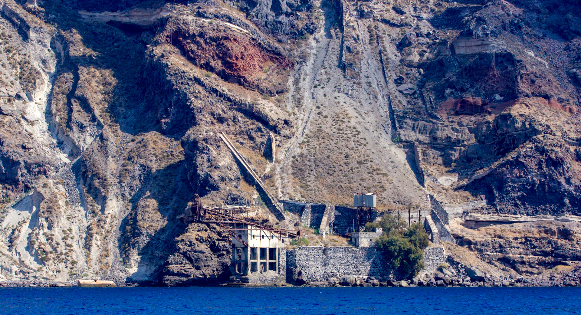 There's been iron ore working on Santorini for a long time, I don't think there's an active mine now. There's some old equipment left behind on the cliffs, and in the sea.