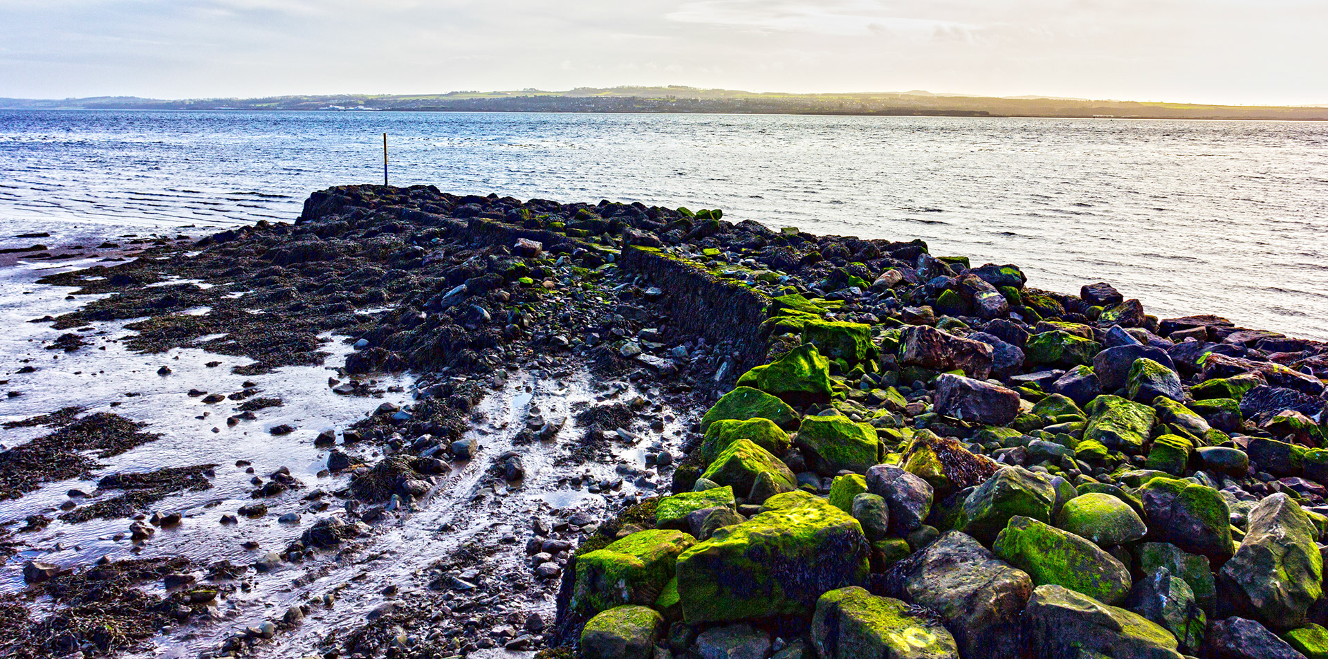 The old historic harbour of Culross, Fife. It is a very old harbour. It was used  as a port in the 1500s &amp; 1600s trading with the  Low Countries and other North Sea Port Towns. Flax, salt and coal were traded, and red pan-tiles were returned as ballast. These tiles are seen on older properties all over Fife &amp; West Lothian (as Blackness did similar trade to Culross). Apparently, even longer ago, monks used the harbour (Maybe not the same one? I'm not sure how old the structure photographed actually is, but Holyrood Abbey was founded in 1128!) to transport quarried stone across the Forth to help build Holyrood Abbey. Please see my other Photographs at: www.jamespdeans.co.uk