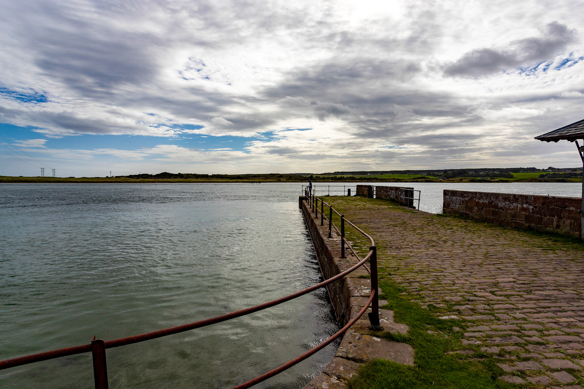Between the main car park and the open sea there is an ancient beach with a shingle ridge. Lichens, heaths and low-growing flowers carpet much of this old beach, with sea lyme and marram grass helping to anchor the sand piled up against the ridge. Sand from the beach and the outermost ridge is being scattered further inland by the wind, but is continuously being replenished by the wave action of the sea.Some of these are thought to be the remains of a Jacobite contingent from Caithness, ambushed at the ferry by a troop of local Royalists on the eve of the Battle of Culloden, 1746.Signs of' the sites busy past are visible; the former pilot's house (the one nearest the sea), the ferryman's house, the ruins of the main store, the Customs and Mussel Inspector building, an ice-house, inn, fishermen's homes and Littleferry House (originally a croft house enlarged into a shooting lodge). The big house on the shore to the west was a granary which has been restored to a single property. Seventy people once lived here but closure of the port led to a decline. Recently more homes have been built in this lovely coastal setting.Littleferry was a crossing point for travellers and the short but dangerous crossing to Coul Links is visible from the pier. Fierce currents caused a number of - fatal ferry accidents, so in 1816 the Mound Embankment, with its then rail and road links, was designed by Thomas Telford. Littleferry is a great point to watch for seals, otters and the huge range of wading birds and wildfowl that inhabit the Loch Fleet National Nature Reserve.