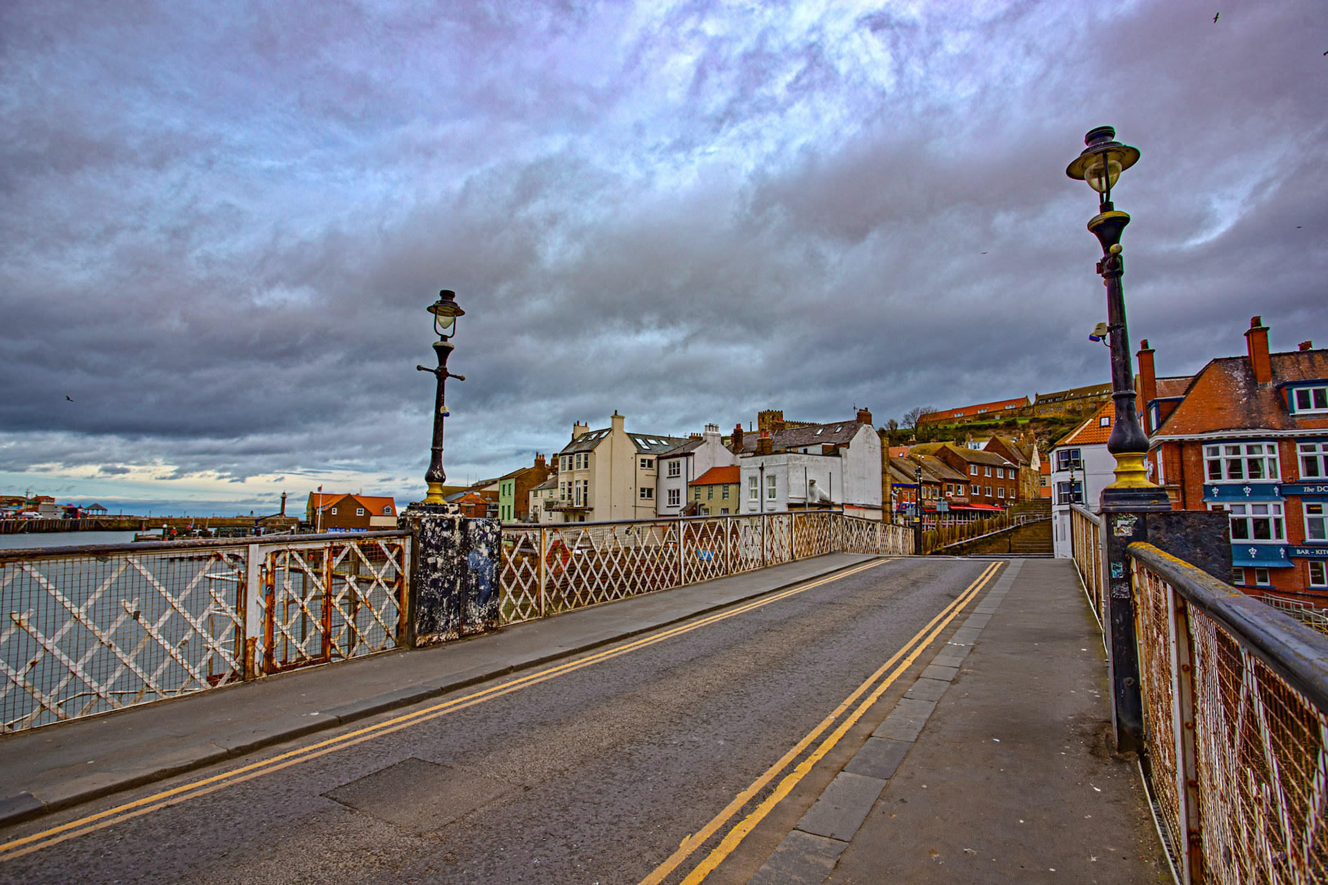Whitby 24 March 2026The present Whitby Bridge was built 1908 to July 1909. It was designed by J. Mitchell Moncrieff who later became President of the Institution of Structural Engineers.It was found as the foundations for the bridge progressed, that there was a 10 inch thick coal seam 26 feet below the mean low water level. So the foundations had to be dug 32 feet (9.8 m) below the mean low water mark to make a good foundation.The weight limit for the bridge was reduced to 7.5 tonnes (8.3 tons) in 2011.