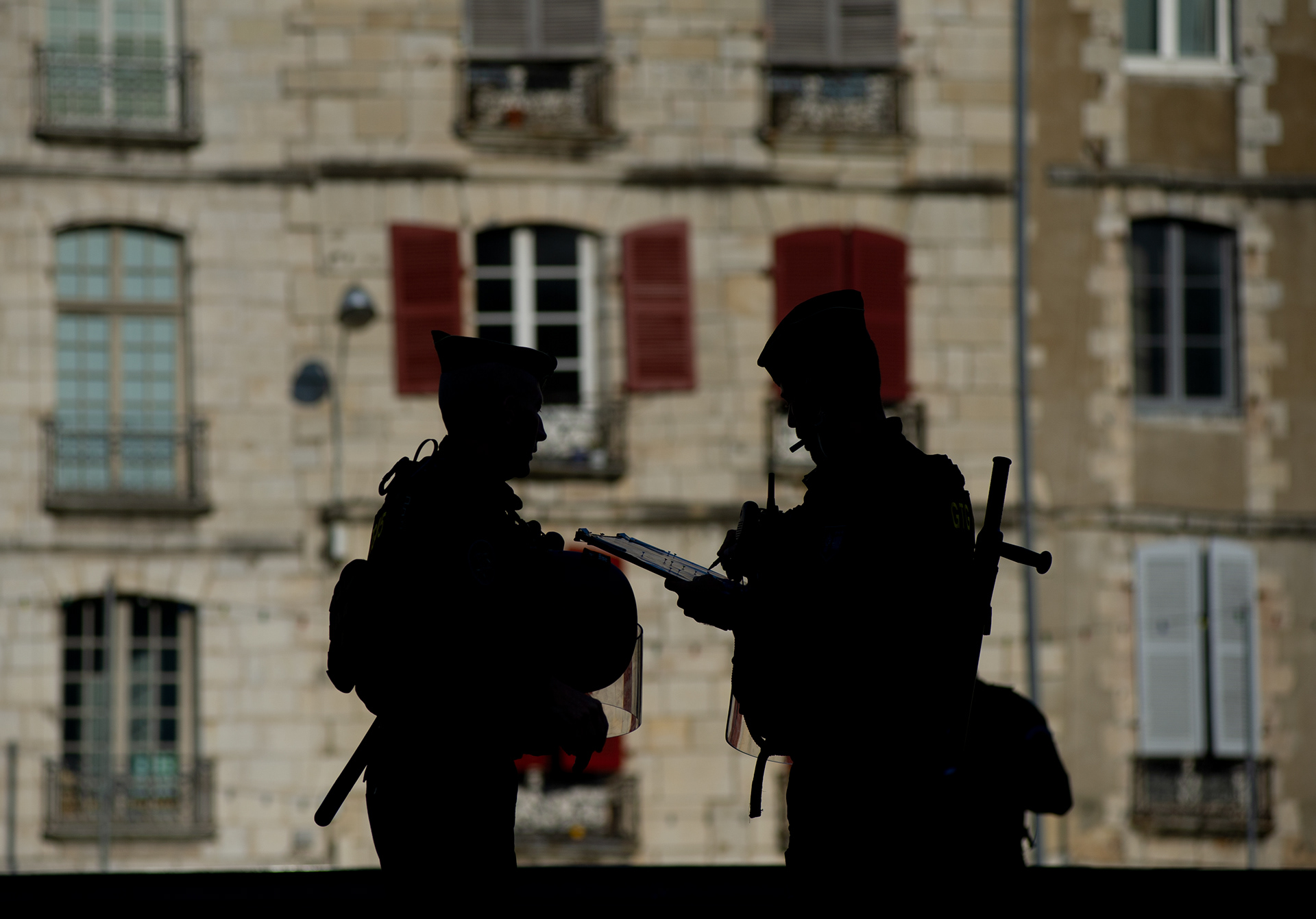 Gendarmerie is seen silhouetted against buildings in Bayonne, France on August 25, 2019.