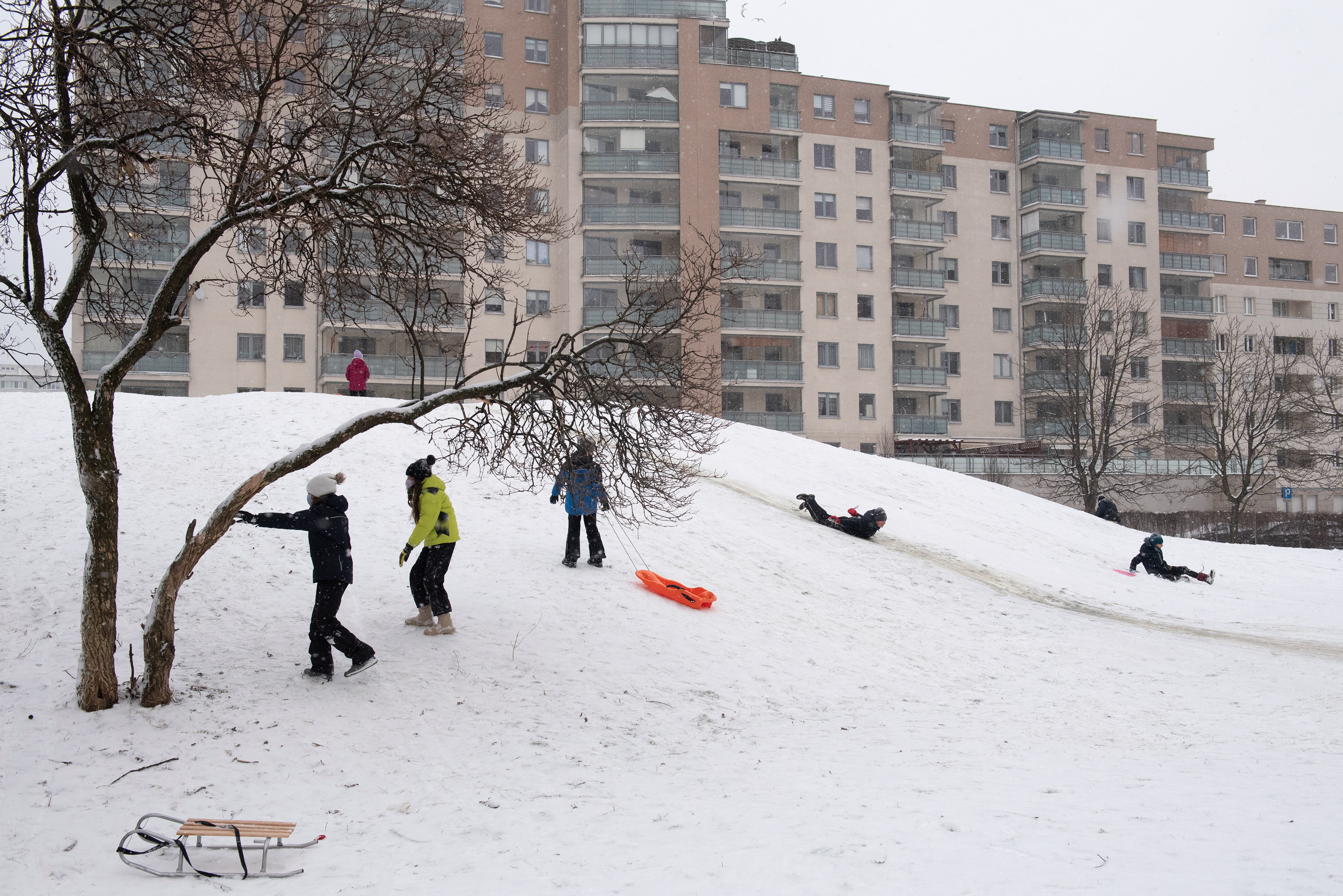 Children play during a snowfall in Warsaw, Poland. 