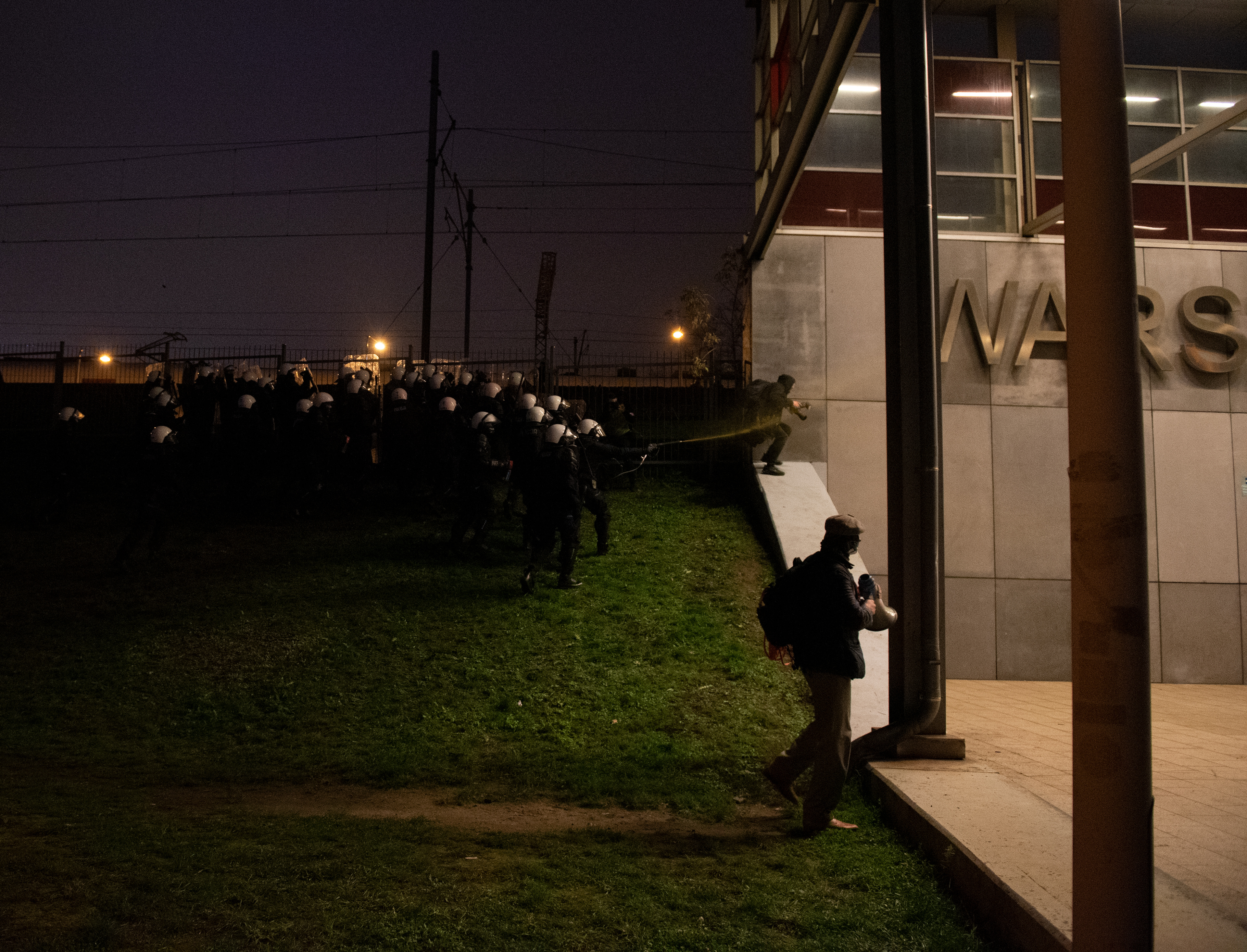 A photojournalist gets pepper-sprayed by riot police during clashes between police and nationalists that took place on November 11, 2020 in Warsaw, Poland during the Independence Day march.
