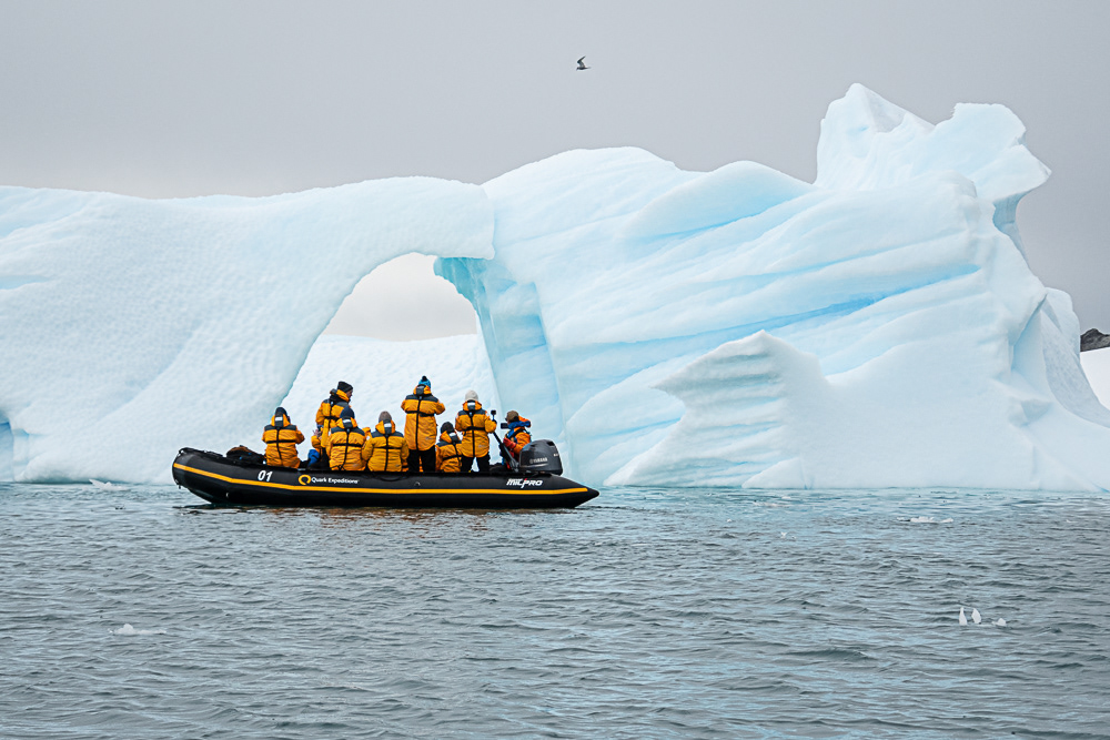 Zodiac Along an Iceberg