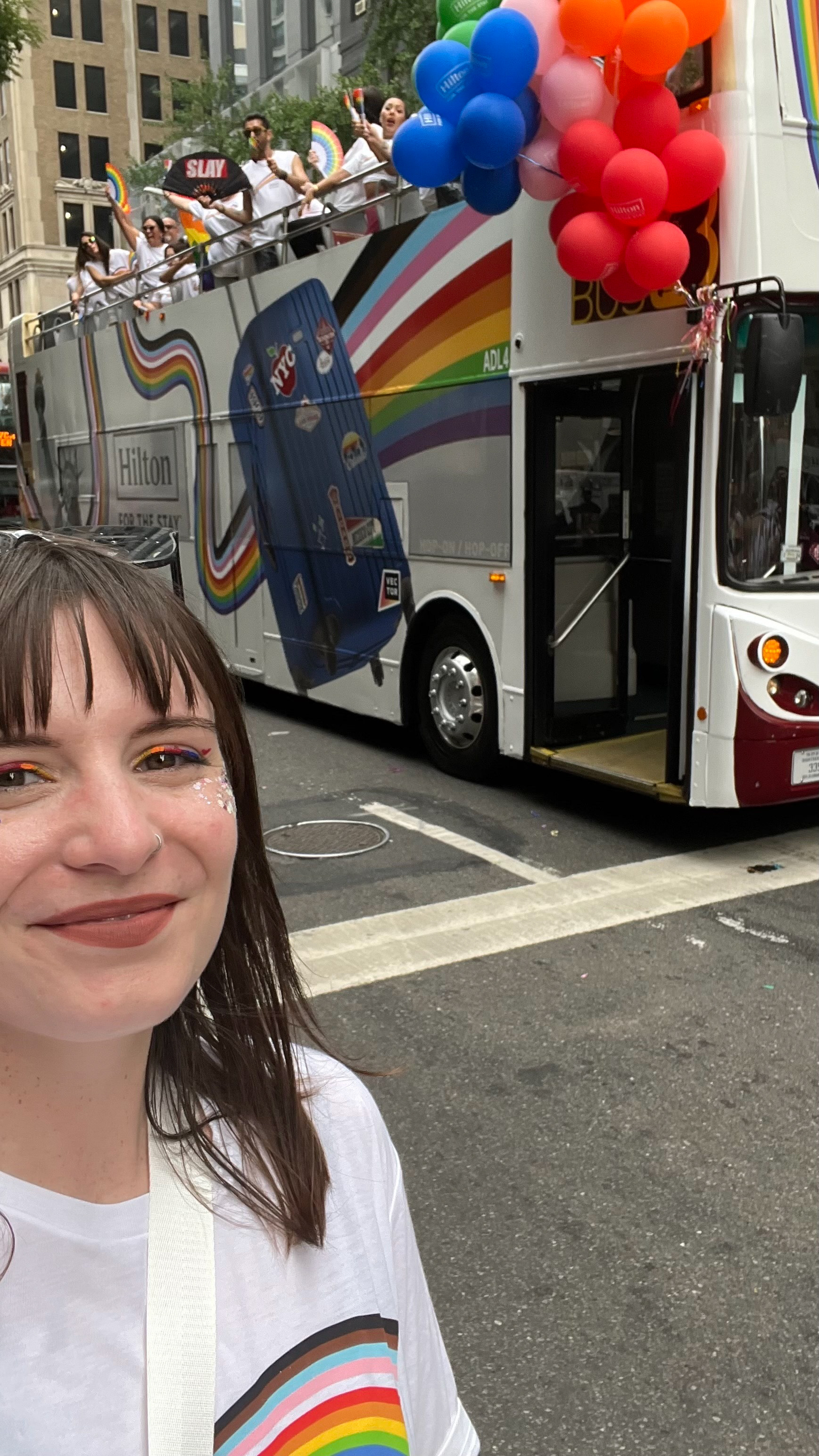 A terrible (sweaty!) pic of me walking in the NYC Pride Parade with my bus design