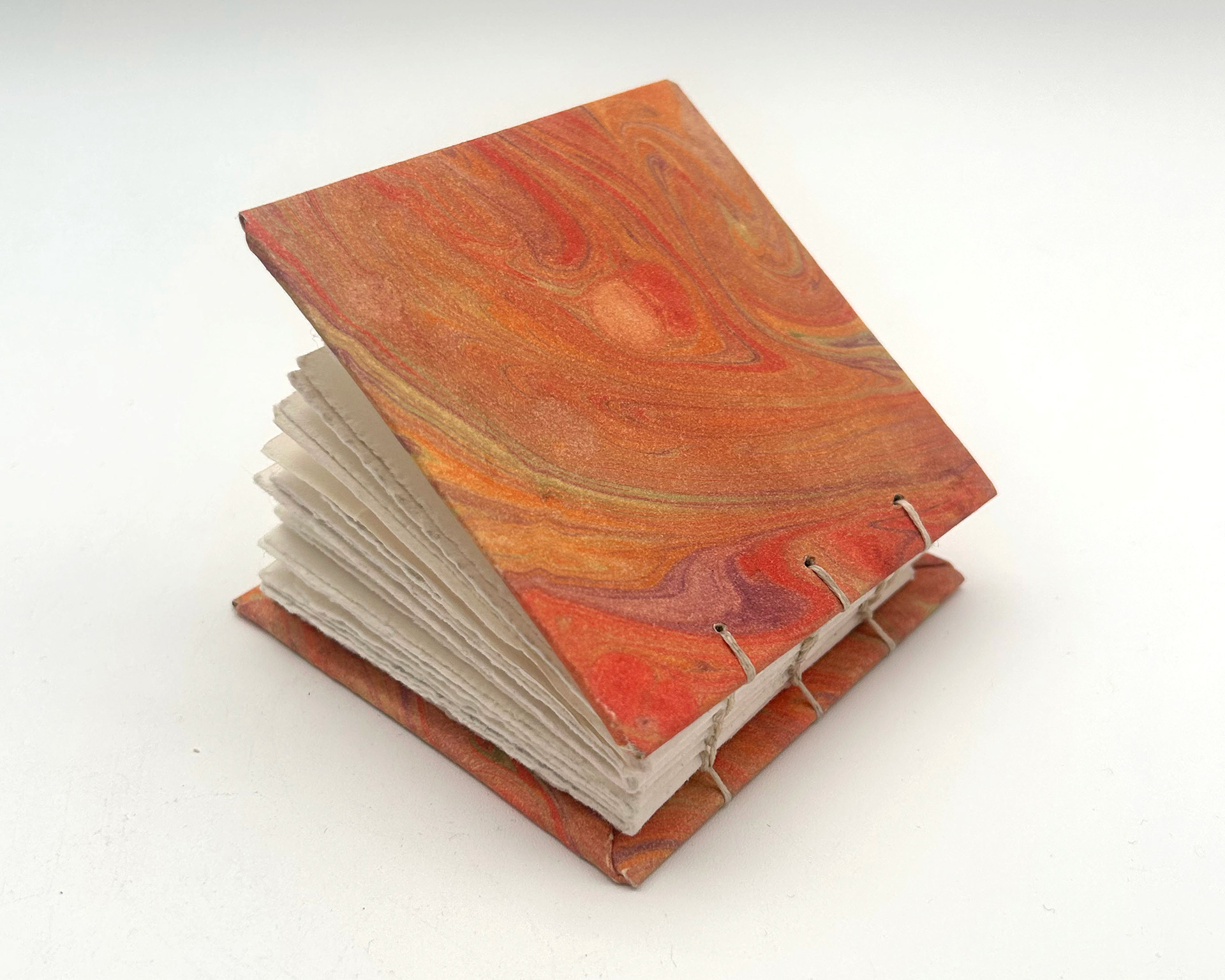 mini book with orange hand marbled covers
