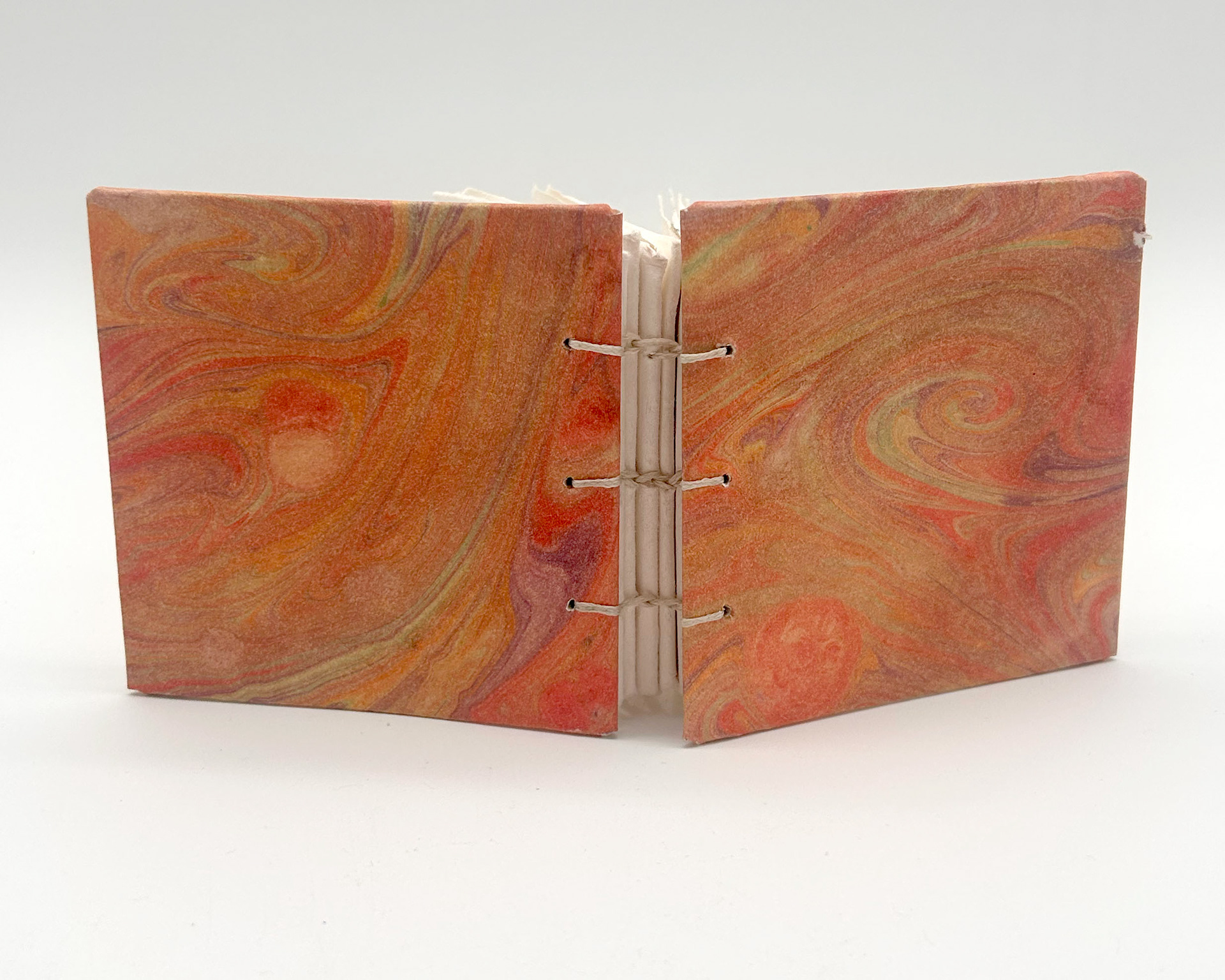 mini book with orange hand marbled covers