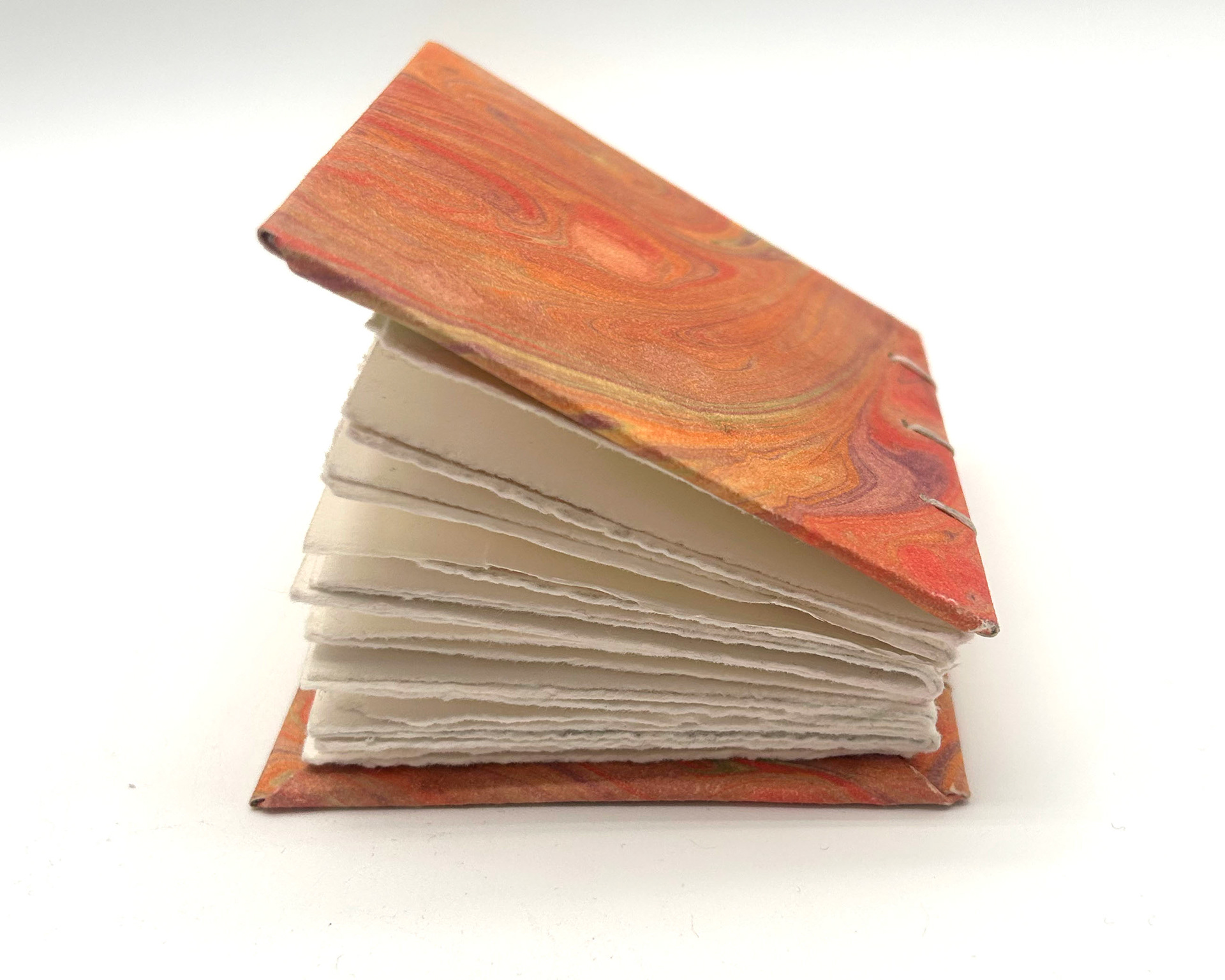 mini book with orange hand marbled covers